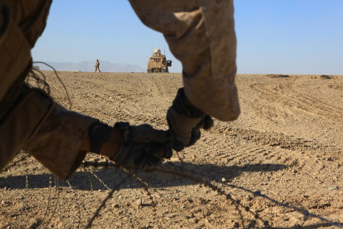 Marines with 9th Combat Engineer Support Battalion, 2nd Marine Logistics Group (Forward), construct concertina wire security elements during a mission in Helmand province, Afghanistan, Dec. 3.  The Marines spent several days building two patrol bases from the ground up.  (U.S. Marine Corps photo by Cpl. Katherine M. Solano)