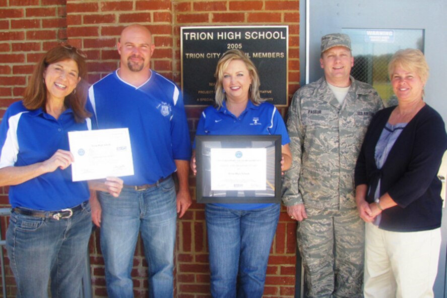 Tech. Sgt. Jason Paseur, Dobbins Air Reserve Base Force Support Squadron member and Trion High School history teacher, presents Mary Myers, Bryan Edge, Ginger Hutchins, and Sally Bohanon the ESGR Above and Beyond and Patriot certificates, which are now on display in the school lobby. Trion received the awards after Tech. Sgt. Jason Paseur, member of the Dobbins' Force Support Squadron and Trion history teacher, wrote an essay to the Awards Committee two years ago demonstrating the lengths Trion has gone in granting him leave for military duty when the Air Force mission requires. (Courtesy photo)