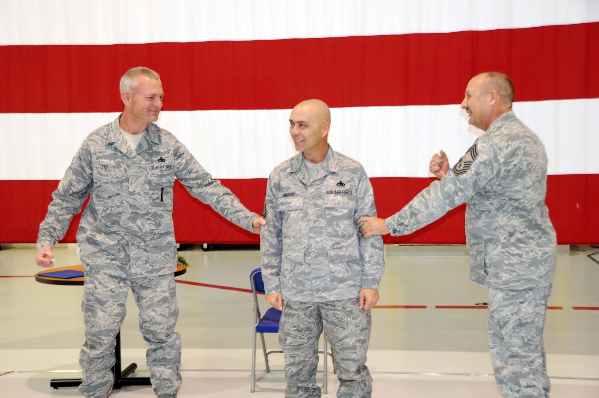 Chief Master Sgt. Darold Fish (left) and Chief Master Sgt. Russell Robinson (right)  tack on chief's rank to newly promoted Chief Master Sgt. Kenneth Gibson during a promotion ceremony, Dec. 1, 2011. Gibson is a weapons loader with the 442nd Aircraft Maintenance Squadorn. The 442nd MXG is part of the 442nd Fighter Wing, an A-10 Thunderbolt II Air Force Reserve unit at Whiteman Air Force Base, Mo. (U.S. Air Force photo/Staff Sgt. Danielle Wolf)