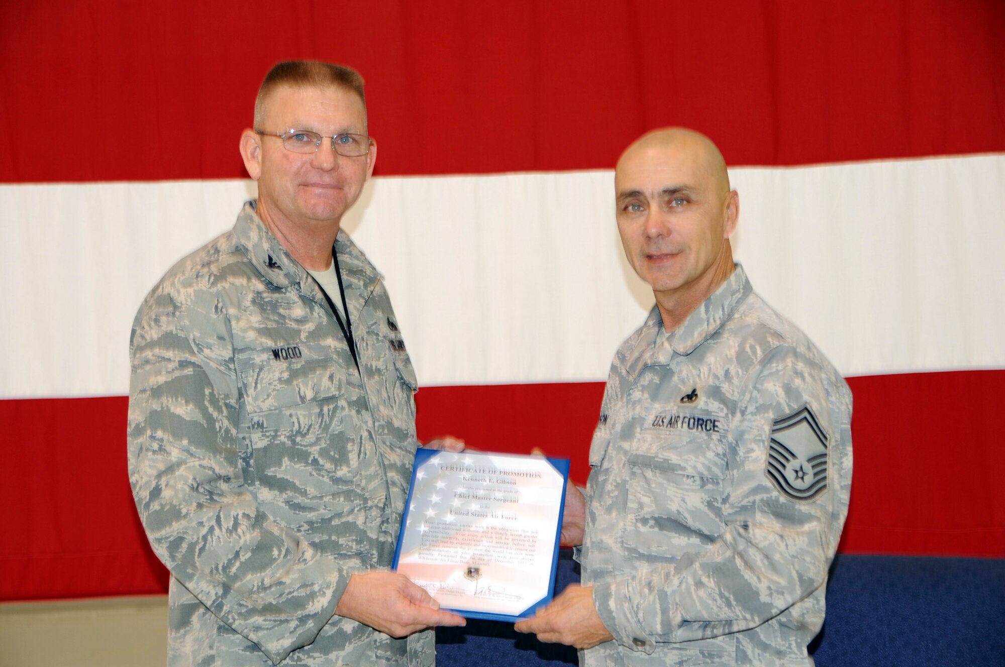Chief Master Sgt. Kenneth Gibson accepts the promotion order from Col. Michael Wood, 442nd Maintenance Group commander, who presided over the promotionc ceremony. Gibson is a weapons loader with the 442nd Aircraft Maintenance Squadorn. The 442nd MXG is part of the 442nd Fighter Wing, an A-10 Thunderbolt II Air Force Reserve unit at Whiteman Air Force Base, Mo. (U.S. Air Force photo/Staff Sgt. Danielle Wolf)