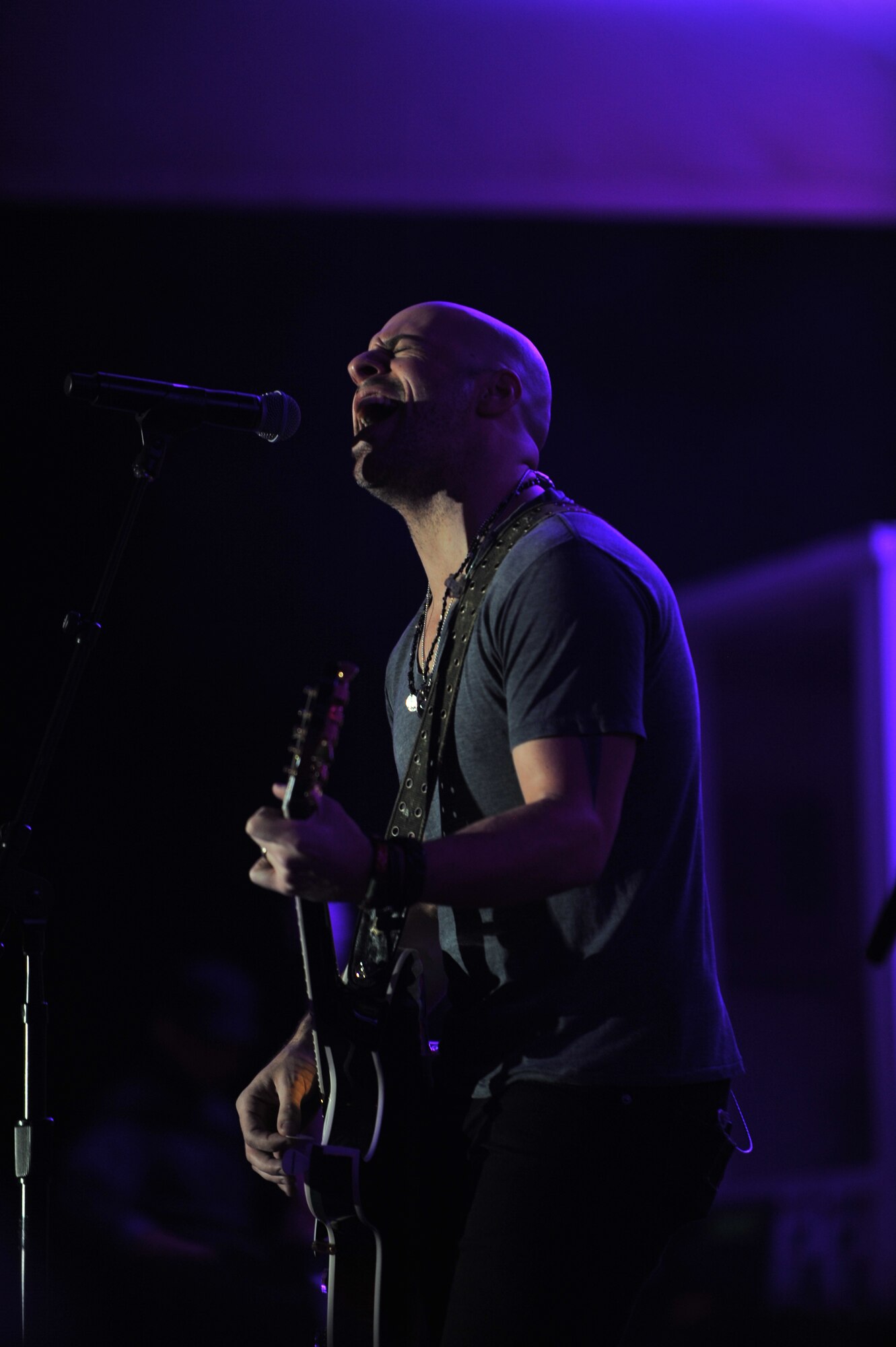 Chris Daughtry, lead singer for the quintuple-platinum band “Daughtry,” performs for service members during a concert at the Memorial Plaza Dec. 2, 2011, at an undisclosed location in Southwest Asia. The rock band Daughtry, comedian Gabriel Iglesias and members of the Band of the U.S. Air Force Reserve began their 13-day tour playing six concerts that will take them through Southwest Asia and Europe to bring entertainment to American troops and their families as part of the 2011 Operation Seasons Greetings Tour for the Troops. (U.S. Air Force photo/Senior Airman Paul Labbe)