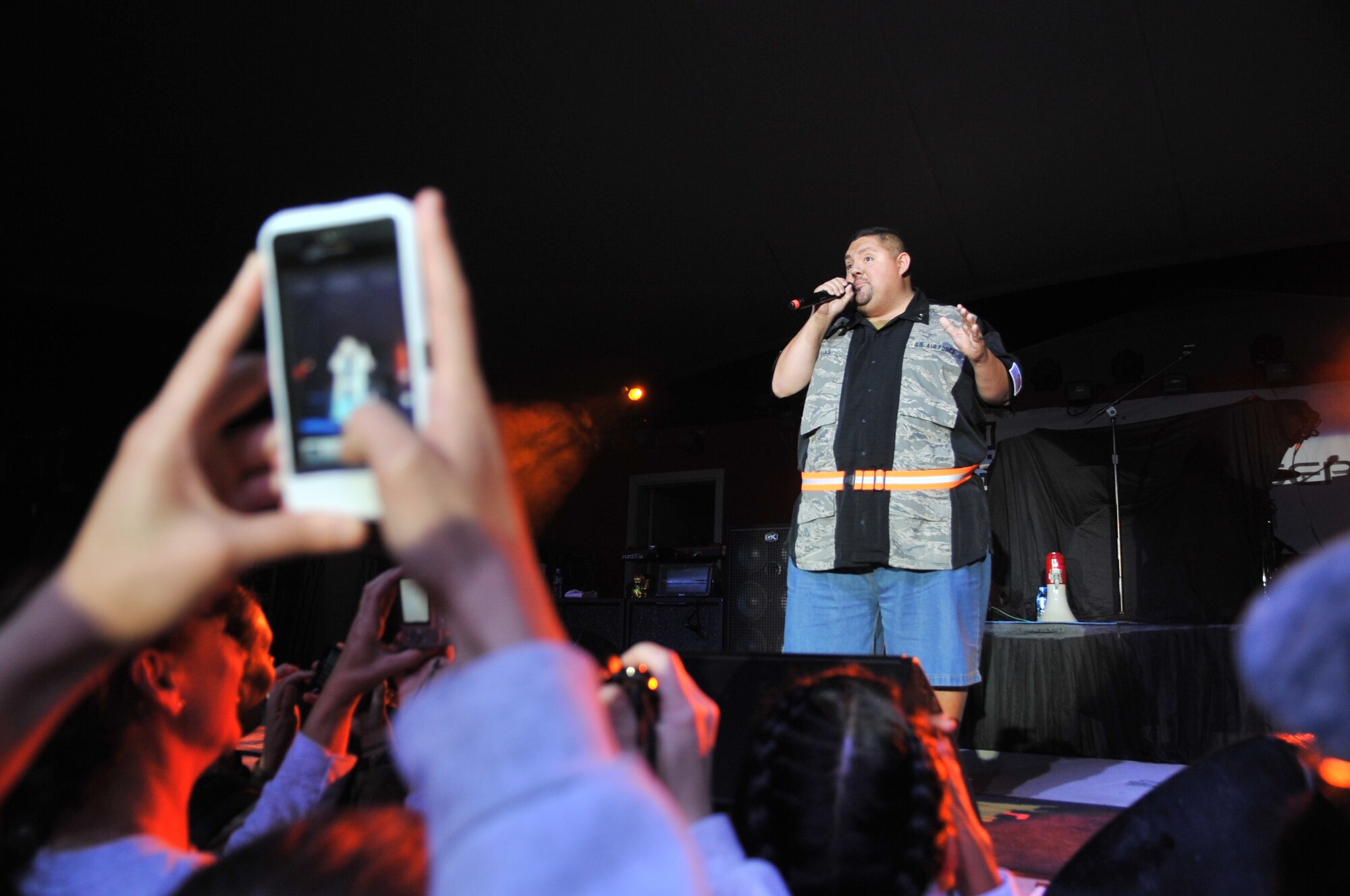 An audience member takes a picture of comedian Gabriel Iglesias while he performs during a concert at the Memorial Plaza Dec. 2, 2011, at an undisclosed location in Southwest Asia. The rock band Daughtry, comedian Gabriel Iglesias and members of the Band of the U.S. Air Force Reserve began their 13-day tour playing six concerts that will take them through Southwest Asia and Europe to bring entertainment to American troops and their families as part of the 2011 Operation Seasons Greetings Tour for the Troops. (U.S. Air Force photo/Senior Airman Paul Labbe)