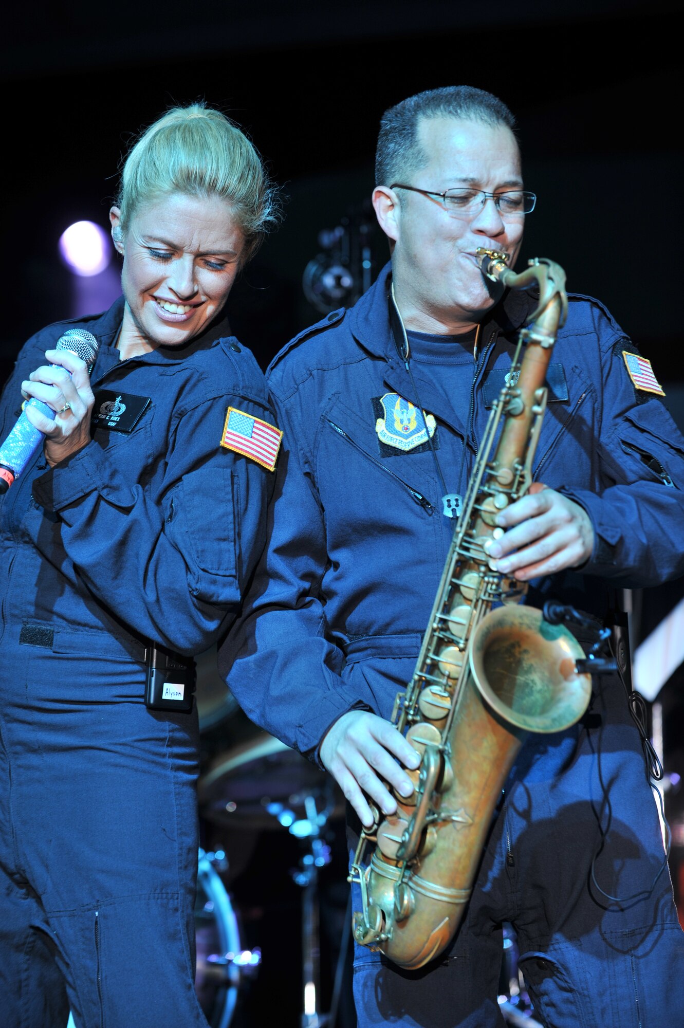 Tech. Sgt. Alyson Jones, Air Force Reserve Band vocalist, and Staff Sgt. Marco Munoz, AFRB saxophonist, both deployed from Robins Air Force Base, Ga., perform together during a concert at the Memorial Plaza Dec. 2, 2011, at an undisclosed location in Southwest Asia. The rock band Daughtry, comedian Gabriel Iglesias and members of the Band of the U.S. Air Force Reserve began their 13-day tour playing six concerts that will take them through Southwest Asia and Europe to bring entertainment to American troops and their families as part of the 2011 Operation Seasons Greetings Tour for the Troops. (U.S. Air Force photo/Senior Airman Paul Labbe)