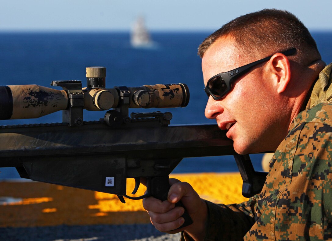 Sergeant Lee Wadsworth, the chief scout with Headquarters and Support Company, Battalion Landing Team 1st Battalion, 2nd Marine Regiment, 24th Marine Expeditionary Unit, sights in on his M-107 sniper rifle during the Defense of the Amphibious Task Force Naval qualification exercise aboard the USS Iwo Jima (LHD 7) Dec. 3, 2011. DATF is one of many qualifications that make up Composite Training Unit Exercise (COMPTUEX), scheduled to take place Nov. 28 to Dec. 21. The training is meant to develop cohesion between the 24th MEU and Amphibious Squadron 8 (PHIBRON-8) in conducting amphibious operations, crisis response, and limited contingency operations while operating from the sea.