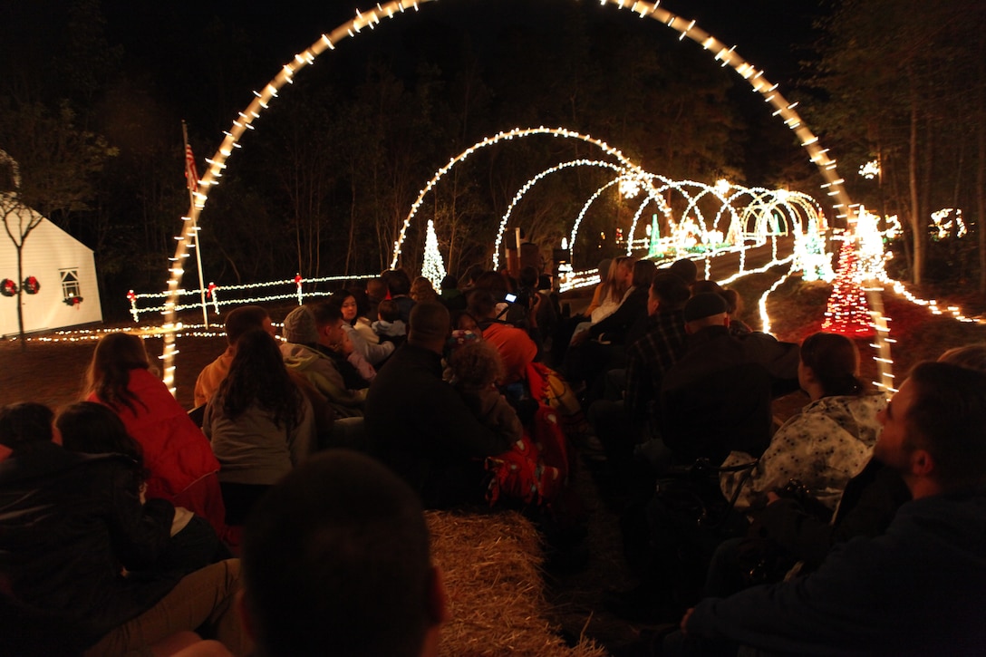 People go through a tunnel of lights during the Holiday Lights, Hayride and Dinner at Mike's Farm on Dec. 4. The event was created by the Midway Park and Tarawa Terrace Community Centers.(Official U.S. Marine Corps Photo by Pfc. Jackeline M. Perez Rivera)::r::::n::