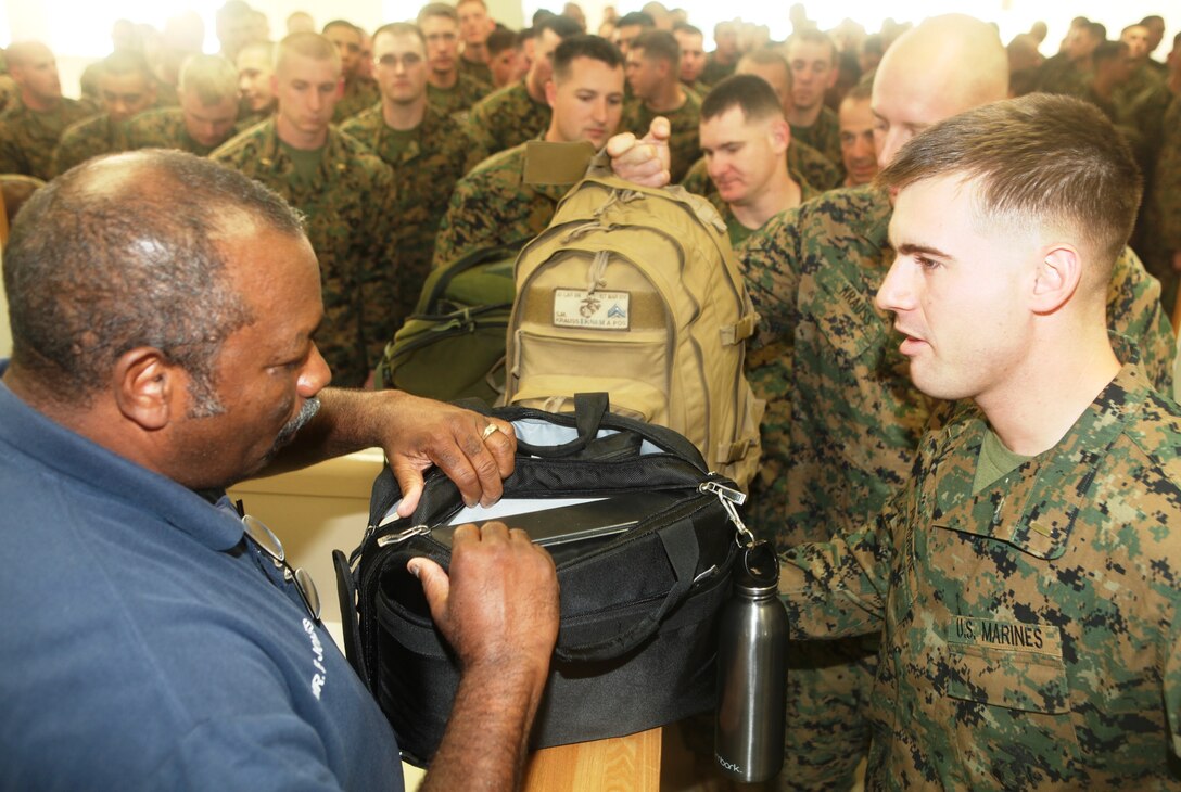 Marines of 1st Battalion, 4th Marine Regiment, from Camp Pendleton, Calif., go through a customs inspection as they arrive and become the new Battalion Landing Team of the 31st Marine Expeditionary Unit, Dec 4. The battalion is now the new ground combat element for the 31st MEU, and is scheduled to embark aboard ships of Amphibious Squadron 11 for deployment in support of Theater Security Cooperation in the Asia-Pacific region. The 31st MEU is America’s force in readiness in the Asia-Pacific region and the only continually forward-deployed MEU.
