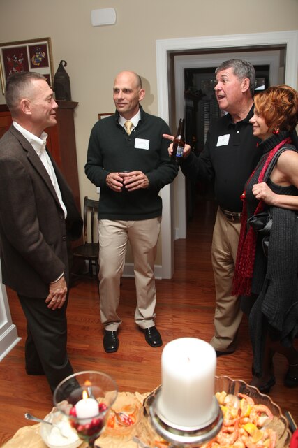 From left to right, Maj. Gen. Jon M. Davis, commanding general of 2nd Marine Aircraft Wing, Col. Kevin M. Iiams, the wing’s standardization officer, Mike Thompson, a member of the Havelock Military Affairs Committee, and Tish Grabnegger, a Distribution Management Office clerk, trade stories of their experiences at the general’s residence aboard Marine Corps Air Station Cherry Point Sunday.