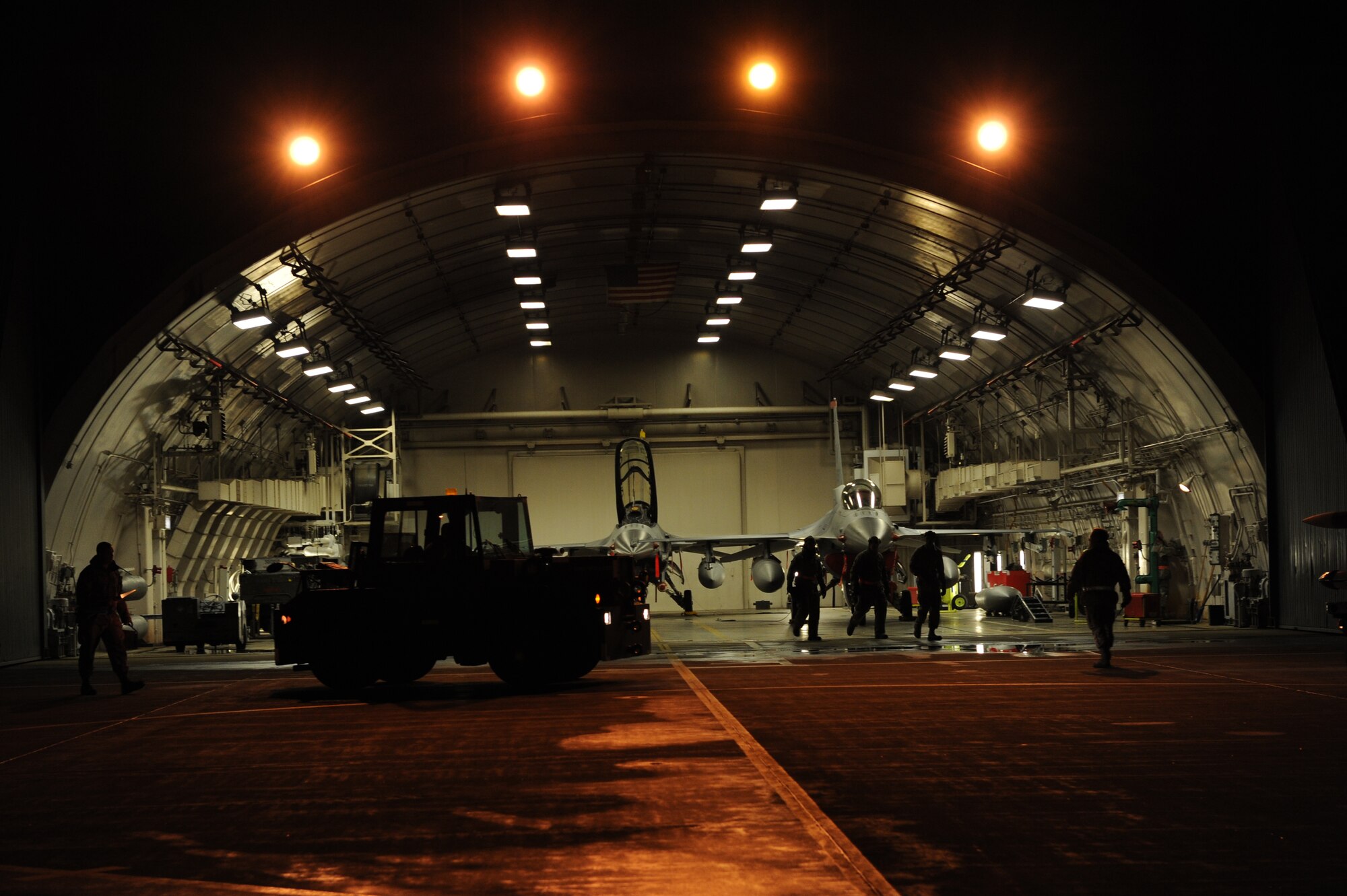 MISAWA AIR BASE, Japan – Members of the 35th Aircraft Maintenance Squadron clear the hangar so that munitions can be loaded during an Operational Readiness Inspection here Dec. 4. The Pacific Air Forces Inspector General Team will spend the next week evaluating the war fighting capability of Misawa’s airmen. (U.S. Air Force photo/Airman 1st Class Kia Atkins) 