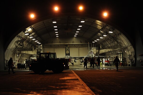 Members of the 35th Aircraft Maintenance Squadron clear the hangar so that munitions can be loaded during an Operational Readiness Inspection at Misawa Air Base, Japan, Dec. 4, 2011. The Pacific Air Forces Inspector General Team will spend the next week evaluating the war fighting capability of Misawa’s airmen. (U.S. Air Force photo/Airman 1st Class Kia Atkins) 
