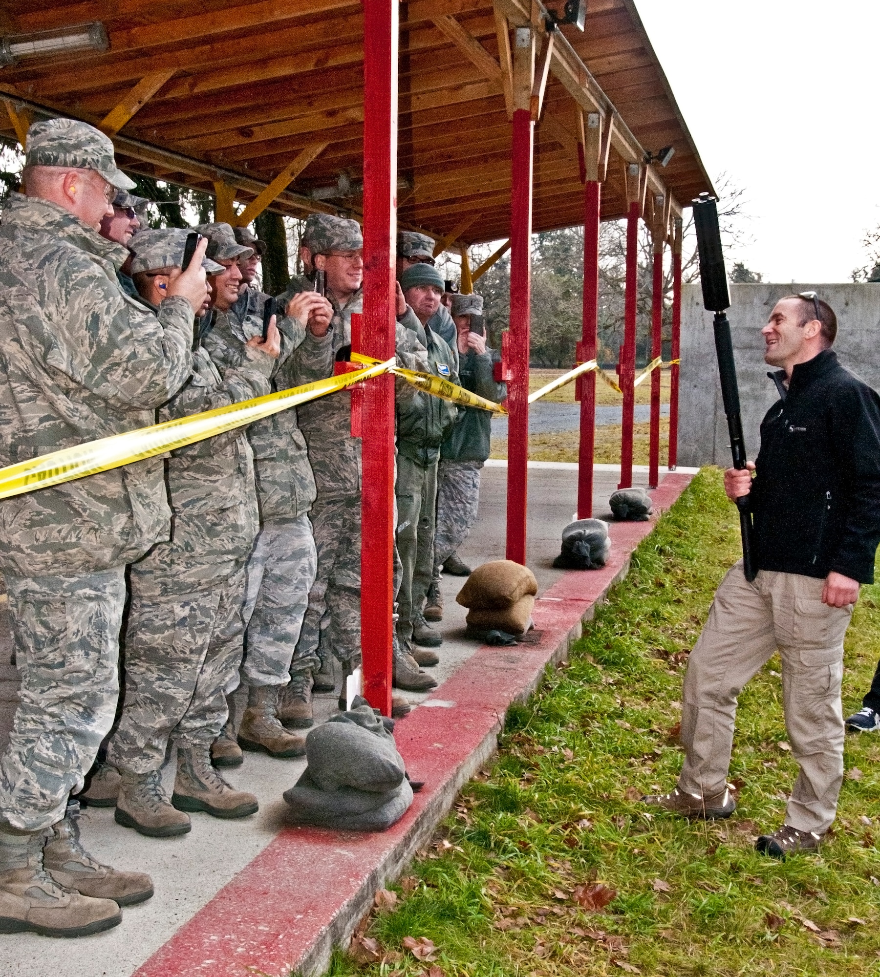 Iain Harrison, the first season winner of the History Channel's "Top Shot," demonstrated to 446th Airlift Wing Reservists how to use various weapons at the firing range Dec. 3, 2011 at Joint Base Lewis-McChord, Wash. Harrison first set foot on McChord Field as a member of the British Army twenty years earlier and returned to take his Oath of Allegiance to become an American citizen.(U.S. Air Force photo by Tech. Sgt. Tanya King/Released)