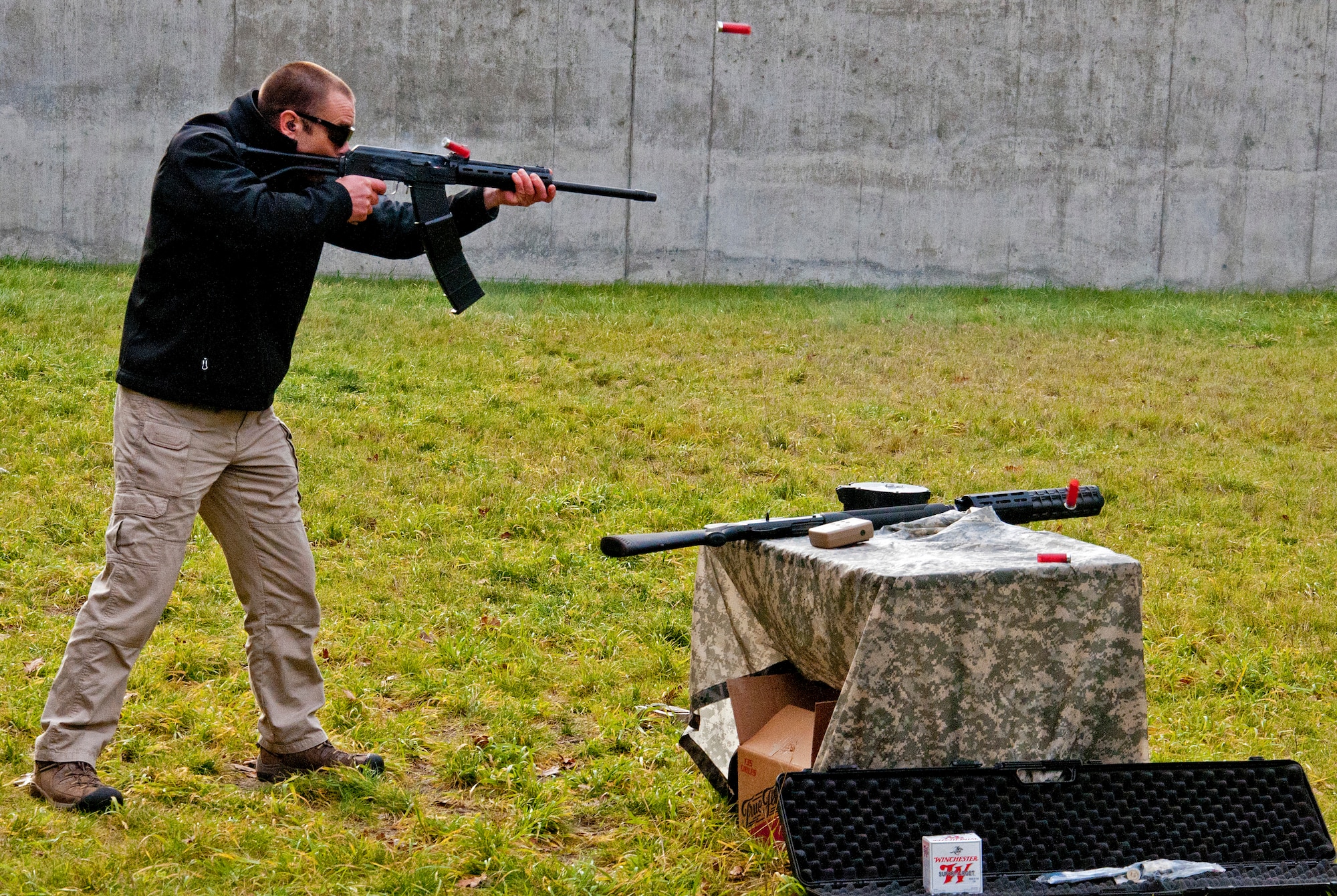 Iain Harrison, the first season winner of the History Channel's "Top Shot," demonstrated to 446th Airlift Wing members how to use various weapons at the firing range Dec. 3, 2011 at Joint Base Lewis-McChord, Wash. Harrison first set foot on McChord Field as a member of the British Army twenty years earlier and returned to take his Oath of Allegiance to become an American citizen. (U.S. Air Force photo by Tech. Sgt. Tanya King/Released)
