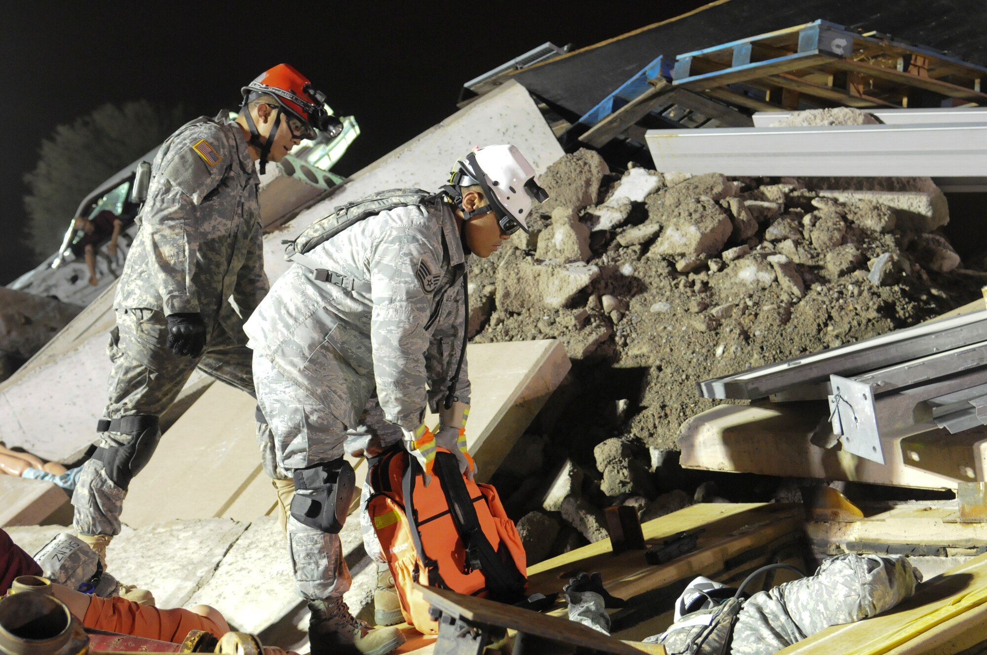 Two search and rescue members prepare to take a wounded victim from a rubble pile as part of a 36-hour specialized training Homeland Response Force exercise in Phoenix, Ariz. on November 5, 2011. (USAF photo by Master Sgt. David J. Loeffler) 