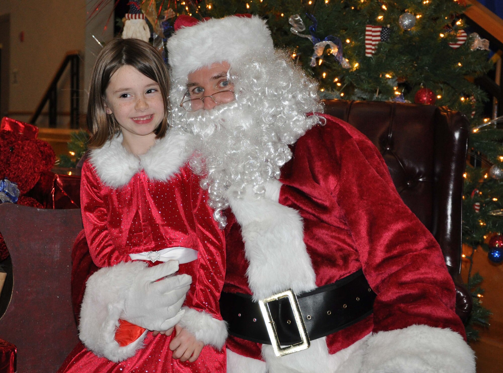 Ashleigh Beabout, daughter of Senior Airman Rob Beabout, 931st Security Forces Squadron, shares her wish list with Santa during a holiday event for children at McConnell Air Force Base, Kan. Dec. 4.  The 931st Air Refueling Group hosted the event, which provided Airmen, their spouses and children an afternoon of making crafts, enjoying holiday treats, and spending some time with Santa. 