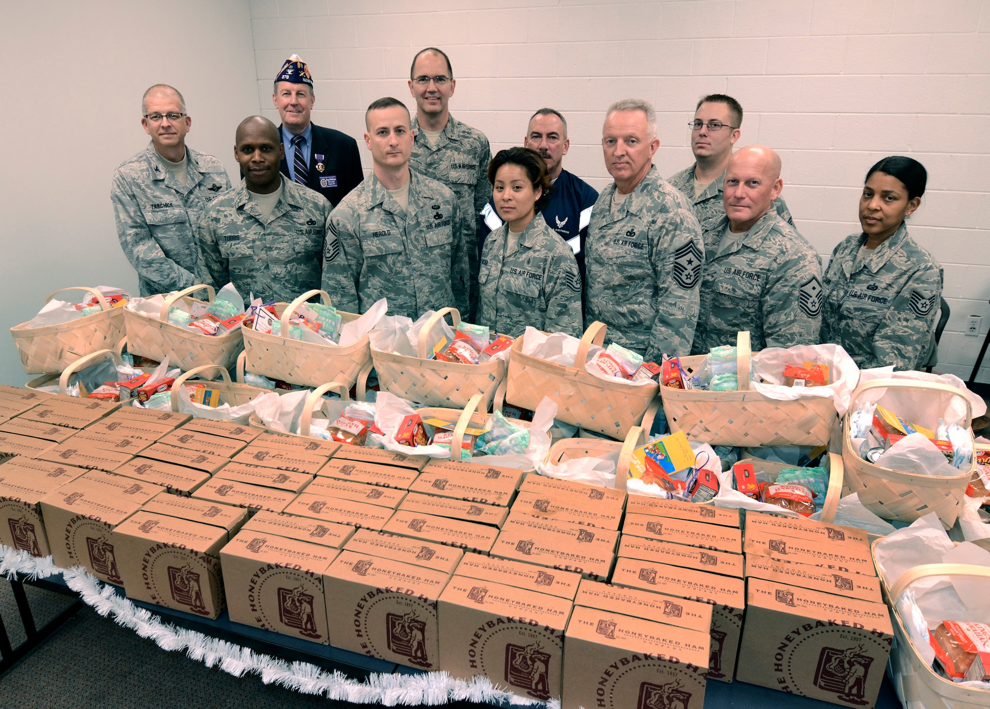 Representatives from chapter 576 of the Military Order of the Purple Heart in Alpharetta present food baskets to senior leaders of the 94th Airlift Wing for distribution to needy Airman, Dec. 3.  (U.S. Air Force photo/ Brad Fallin)  