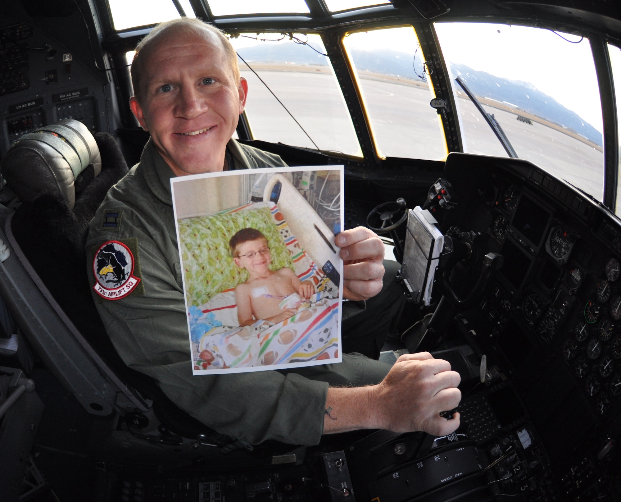 Air Force Reserve Capt. Robert Wilson gives the gift of life to a seven-year-old boy, some 1,800 miles away. Capt. Wilson holds a photo of A.J., during one of his stays in the hospital. (U.S. Air Force photo/ Staff Sgt. Stephen J. Collier)  