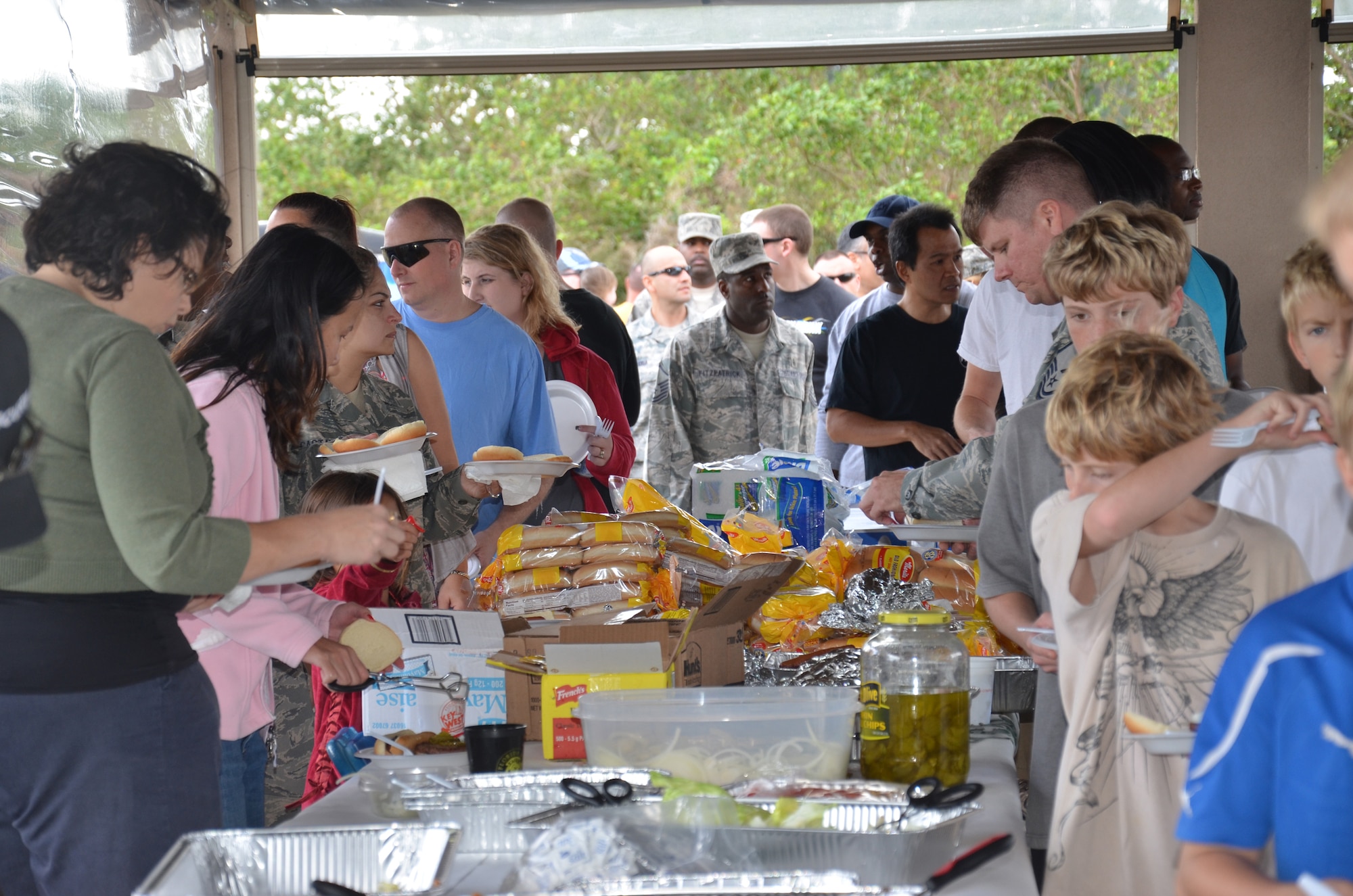 PATRICK AIR FORCE BASE, Fla.- Rescue Airmen and family members wait in line to make plate of food at the family holiday picnic here. "We couldn't do this without family," said wing commander, Col. Jeffery Macrander. The unit's peacetime missions are providing search and rescue support for civilians at sea who are lost or in distress, and providing humanitarian and disaster-relief operations. (U.S. Air Force photo/Staff Sgt. Anna-Marie Wyant)