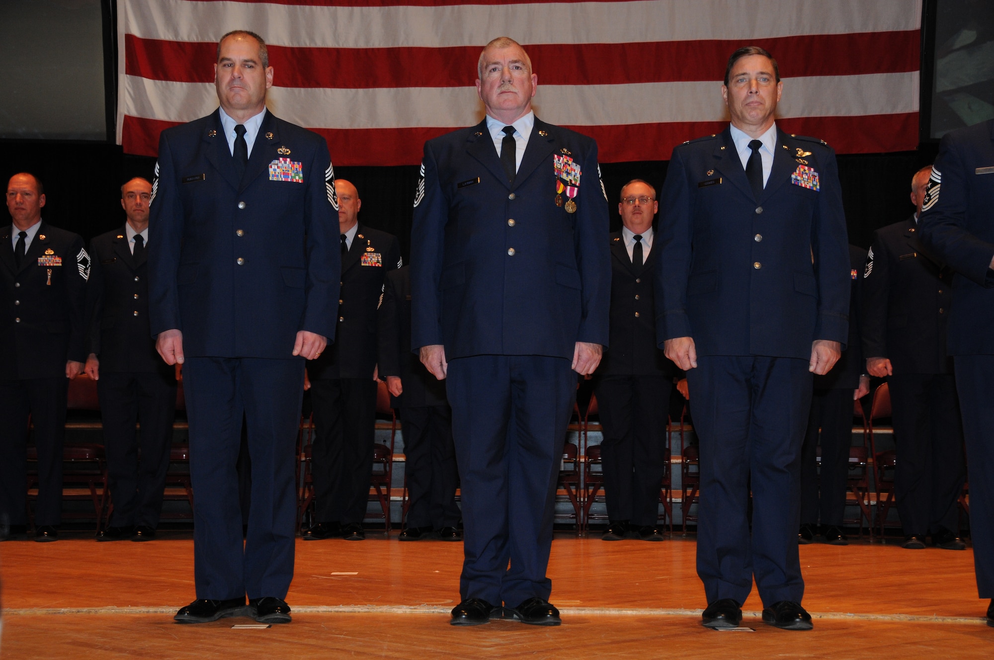 148th Fighter Wing Command Chief Master Sgt. Mark Rukavina, Command Chief Master Sgt.  Michael Layman, and 148th Fighter Wing Commander Col. Frank Stokes stand during the transfer of authority ceremony held Dec. 4, 2011 in Duluth, Minn.  The command chief is the representative of all the enlisted personnel at the 148th, and is the liasion between the commander and the enlisted Airmen. (National Guard photo by Tech. Sgt. Brett Ewald)