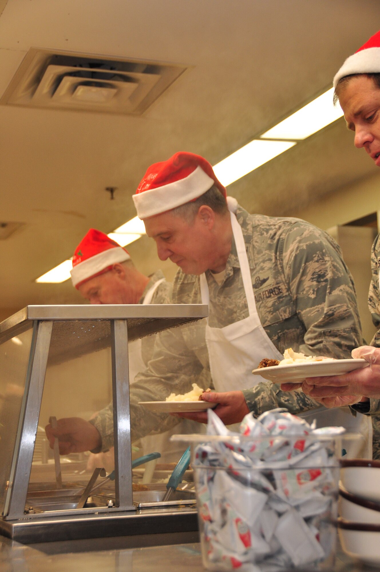 Col. Darrell G. Young, 934th Airlift Wing commander, serves up holiday cheer at the Dining Facility Dec. 3. (Air Force photo/ Tech. Sgt. Jim Loehr)  