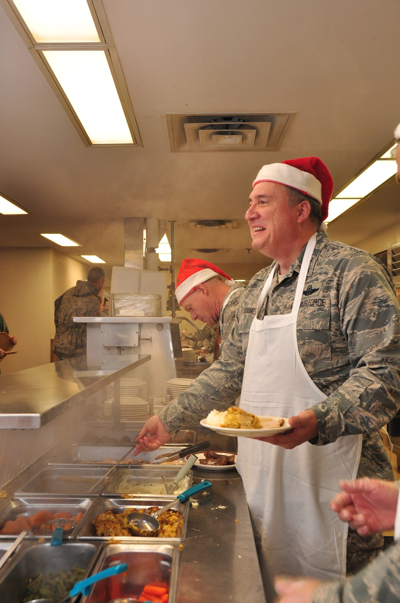 Col. Darrell G. Young, 934th Airlift Wing commander, serves up holiday cheer at the Dining Facility Dec. 3. (Air Force photo/ Tech. Sgt. Jim Loehr)   