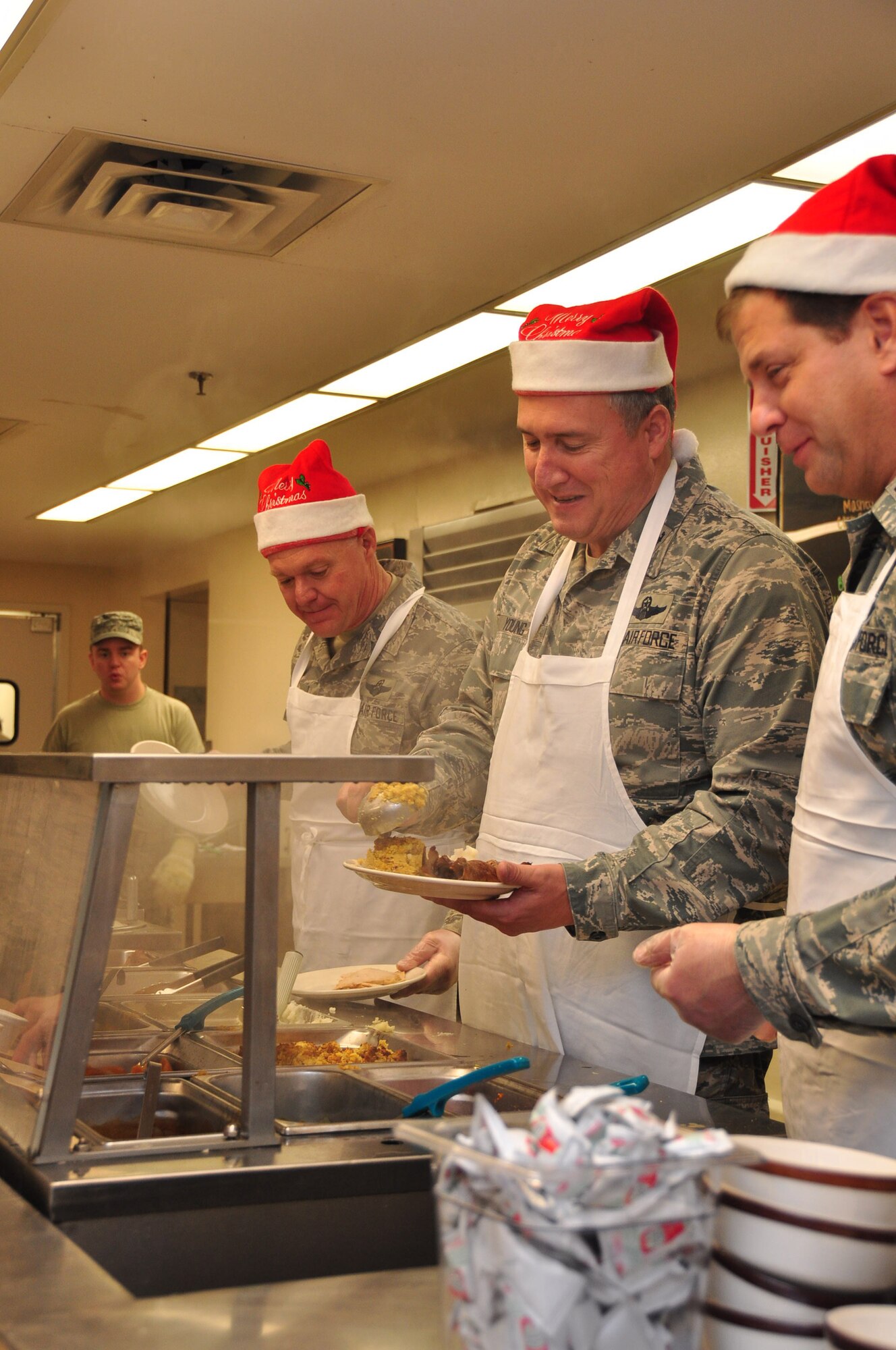 Colonel Darrell G. Young Wing Commander of the 934th Air Lift Wing serves up holiday cheer at the DFAC, December 3 2011 (Aire Force photo/ TSgt Jim Loehr)  