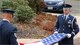 Technical Sergeants Matt Swindlehurst (right) and Dana Granteed, both of the 439th Airlift Wing honor guard, fold the U.S. flag after lowering it from half staff during a Veteran's Day ceremony in Sunderland, Mass.