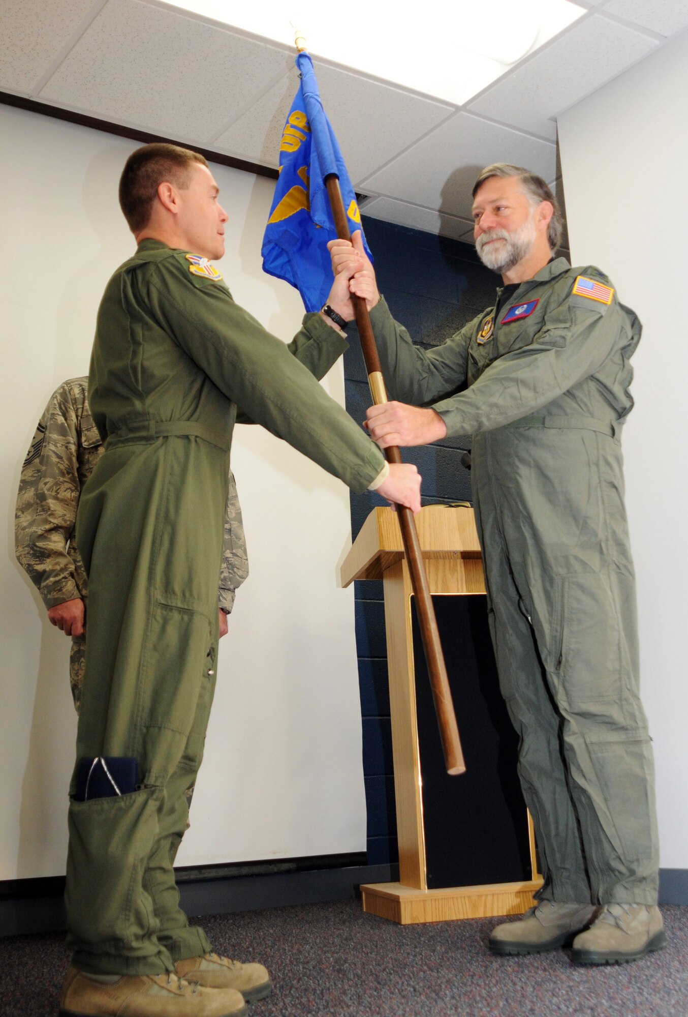 YOUNGSTOWN AIR RESERVE STATION, Ohio --    Air Force Reserve Col. Craig Peters, commander of the 910th Operations Group passes his unit's flag to David Deibel, president of Boardman Steel and vice president of the Youngstown Air Reserve Base Community Council during the operations group's first honorary commanders program December 3.  "Mr. Deibel has been an avid contributor of our base by advocating for military members and their families in the Youngstown Community for over 25 years," said Col. Peters.  "His participation in fundraisers, air shows, open houses, family days, the military ball, the Pilot for a day program, and other events has been his way of giving back to his community and supporting the nation that he loves," he concluded.   The 910th Operations Group Honorary Commanders Program was designed to encourage an exchange of ideas, experiences, and friendships between key members of the community and the men and women of the 910th Operations Group. U.S. Air Force photo by Tech. Sgt. Matt Matulka