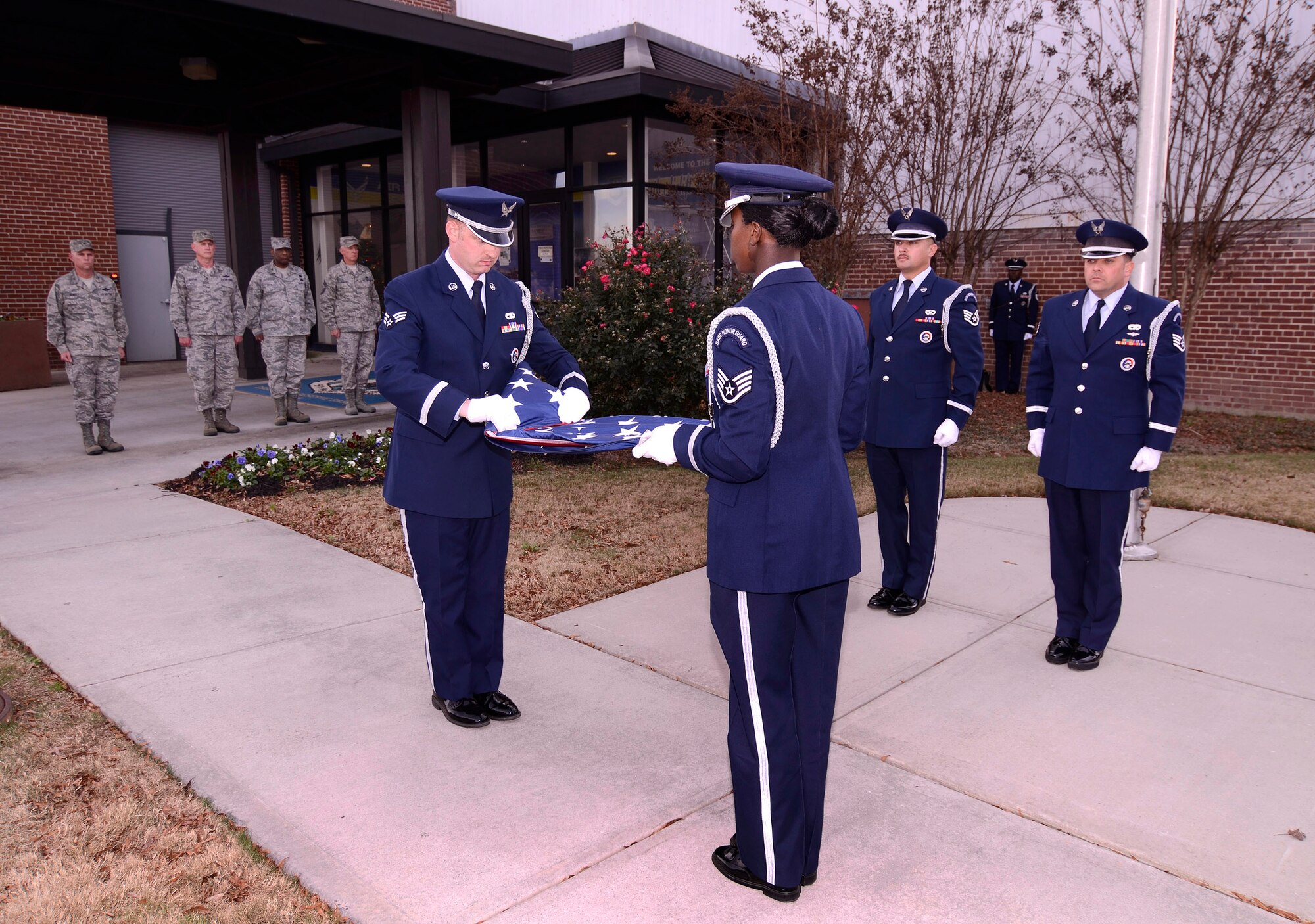 Wing staff members from the base Honor Guard of the 94th Airlift Wing, fold the US flag during a retreat ceremony for the December Unit Training Assembly at Dobbins Air Reserve Base, Ga, Dec. 3.  (U.S. Air Force photo/ Brad Fallin)