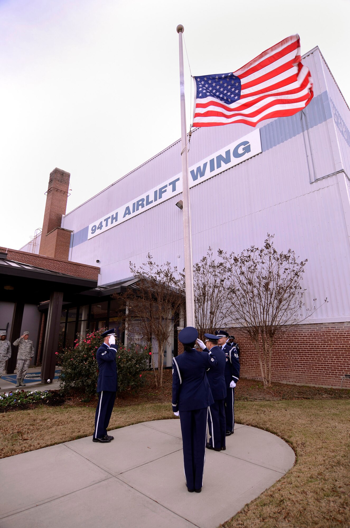 Wing staff members from the base Honor Guard of the 94th Airlift Wing, lower the US flag during a retreat ceremony for the December Unit Training Assembly at Dobbins Air Reserve Base, Ga, Dec. 3.  (U.S. Air Force photo/ Brad Fallin)