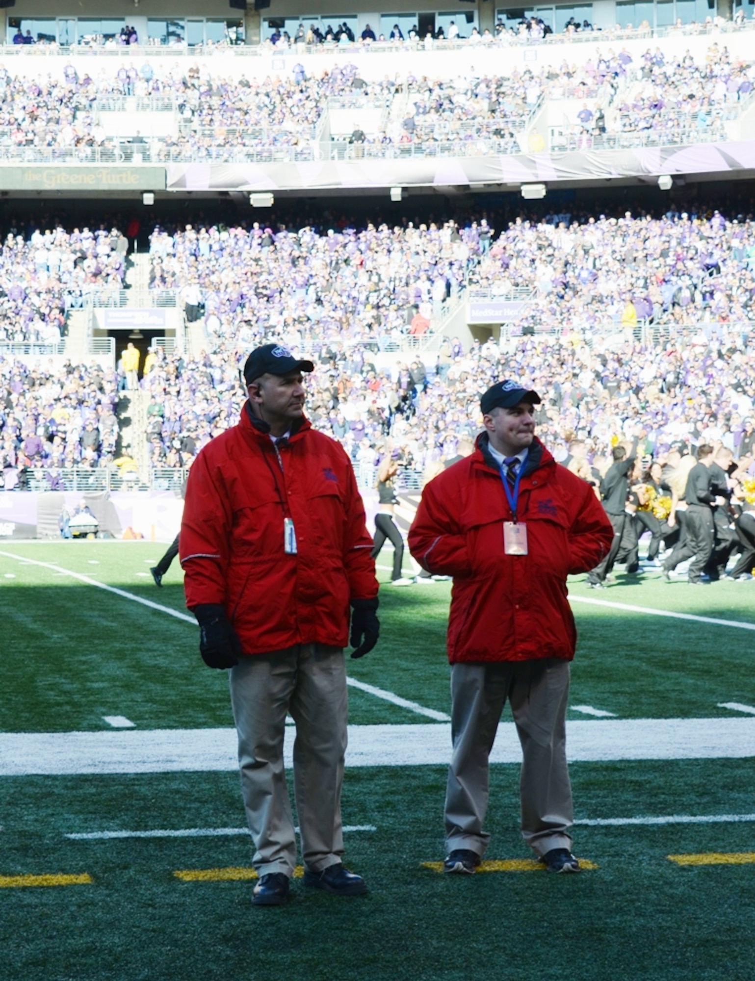 Tracy Brandenberg, left, works security on the sidelines of Baltimore Ravens game on Oct. 30, 20112.. (National Guard photo by Master Sgt. Ed Bard/RELEASED)
