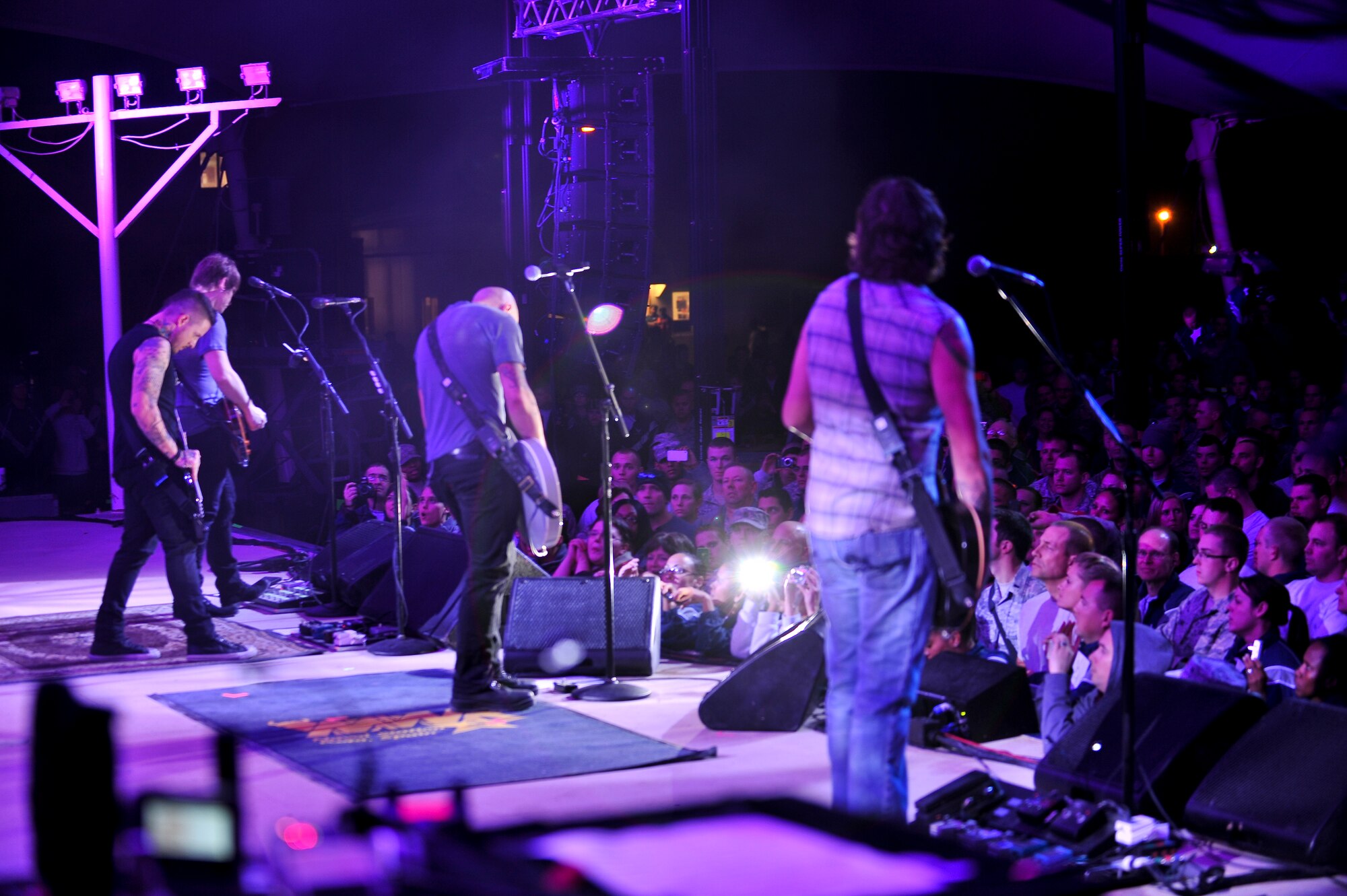 The quintuple-platinum band “Daughtry” plays one of their hit singles for deployed service members during a concert at the Memorial Plaza Dec. 2, 2011, at an undisclosed location in Southwest Asia. The rock band Daughtry, comedian Gabriel Iglesias and members of the Band of the U.S. Air Force Reserve began their 13-day tour playing six concerts that will take them through Southwest Asia and Europe to bring entertainment to American troops and their families as part of the 2011 Operation Seasons Greetings Tour for the Troops. (U.S. Air Force photo/Senior Airman Paul Labbe)