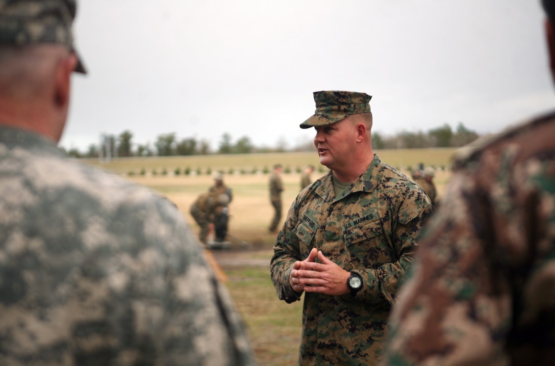 1st Sgt. Eric Sheppard, the first sergeant for Infantry Training Battalion, School of Infantry East, explains a mortarman’s job during a tour of the School of Infantry East aboard Camp Geiger, N.C., Dec. 5, 2011. During the tour, Jordanian senior enlisted leaders were walked through classes and demonstrations throughout Infantry Training Battalion, SOI East. (U.S. Marine Corps photo by. Pfc. Franklin E. Mercado)