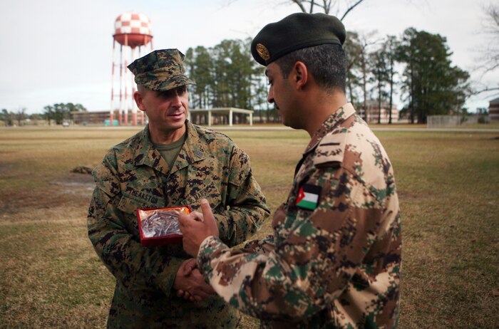 Sgt. Maj. Scott Theakston, the School of Infantry sergeant major, receives a token of appreciation from the Jordanian senior enlisted leaders during a tour of the School of Infantry East aboard Camp Geiger, N.C., Dec. 5, 2011. During the tour, Jordan’s top enlisted leaders from its different branches were walked through classes and demonstrations throughout Infantry Training Battalion, SOI East.  (U.S. Marine Corps photo by. Pfc. Franklin E. Mercado)
