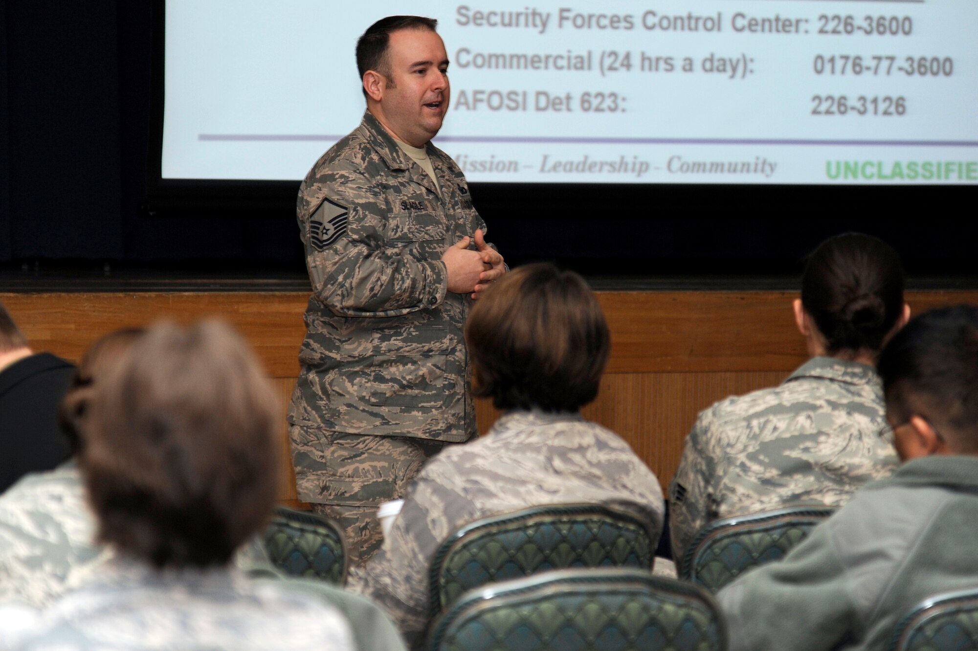 MISAWA AIR BASE, Japan - Master Sgt. Robert Slagle, 35th Security Forces Squadron, briefs military dependents on the Eagle Eyes program during a mock town hall meeting of an operational readiness inspection here Dec. 6. Town Hall meetings are held to inform dependents of base services available to them and to update them on current situations. Members of the 35th Fighter Wing are going through an ORI to test airmen's war deployment abilities. (U.S. Air Force photo/Tech. Sgt. Marie Brown)