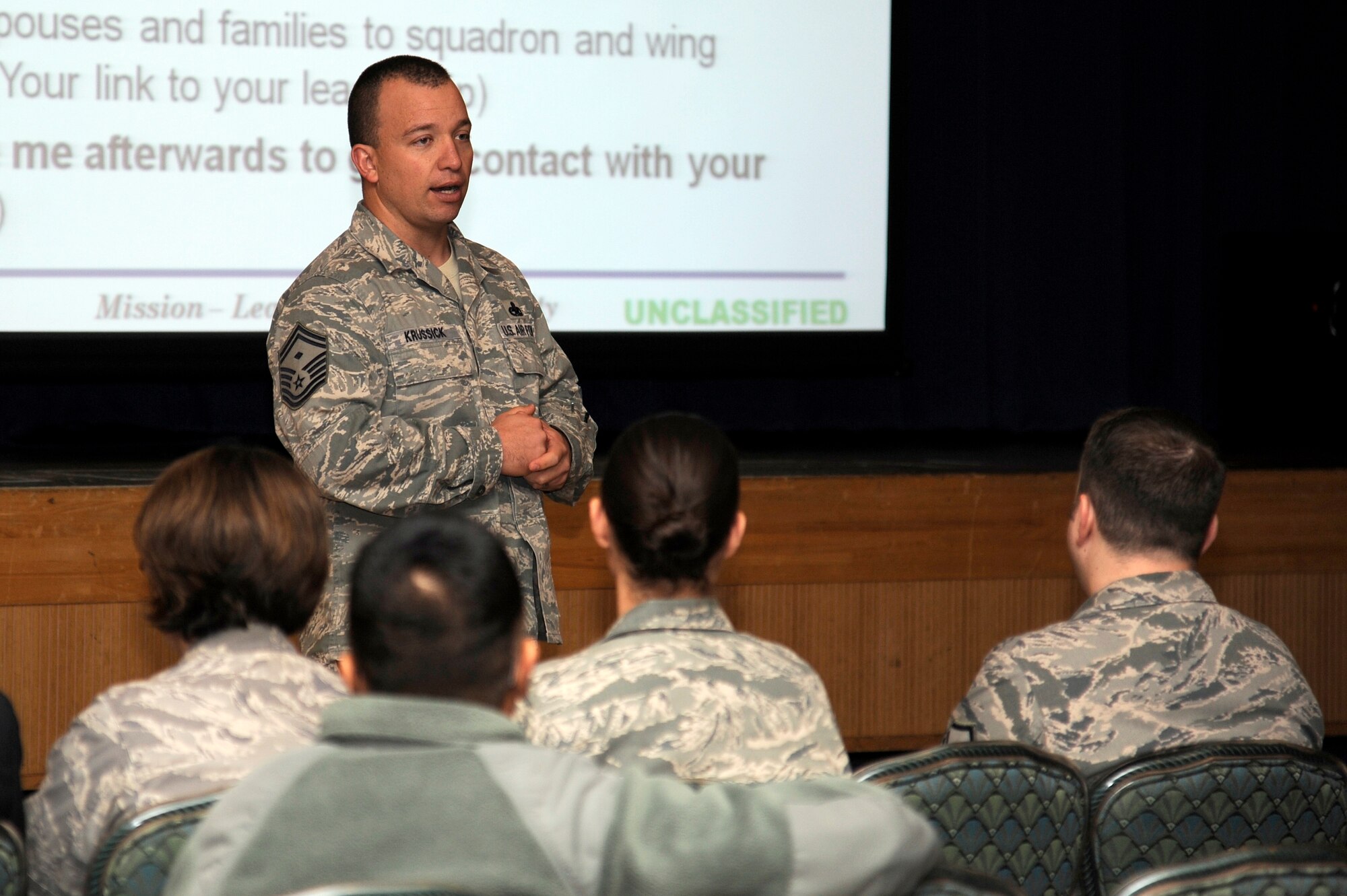 MISAWA AIR BASE, Japan - Senior Master Sgt. Joseph Krussick, 35th Logistics Readiness Squadron, briefs military dependents on the Key Spouse program during a mock town hall meeting during an operational readiness inspection here Dec. 6. Town Hall meetings are held to inform dependents regarding base services available to them and to update them on current situations. Members of the 35th Fighter Wing are going through an ORI to test airmen's deployment capabilities. (U.S. Air Force photo/Tech. Sgt. Marie Brown)