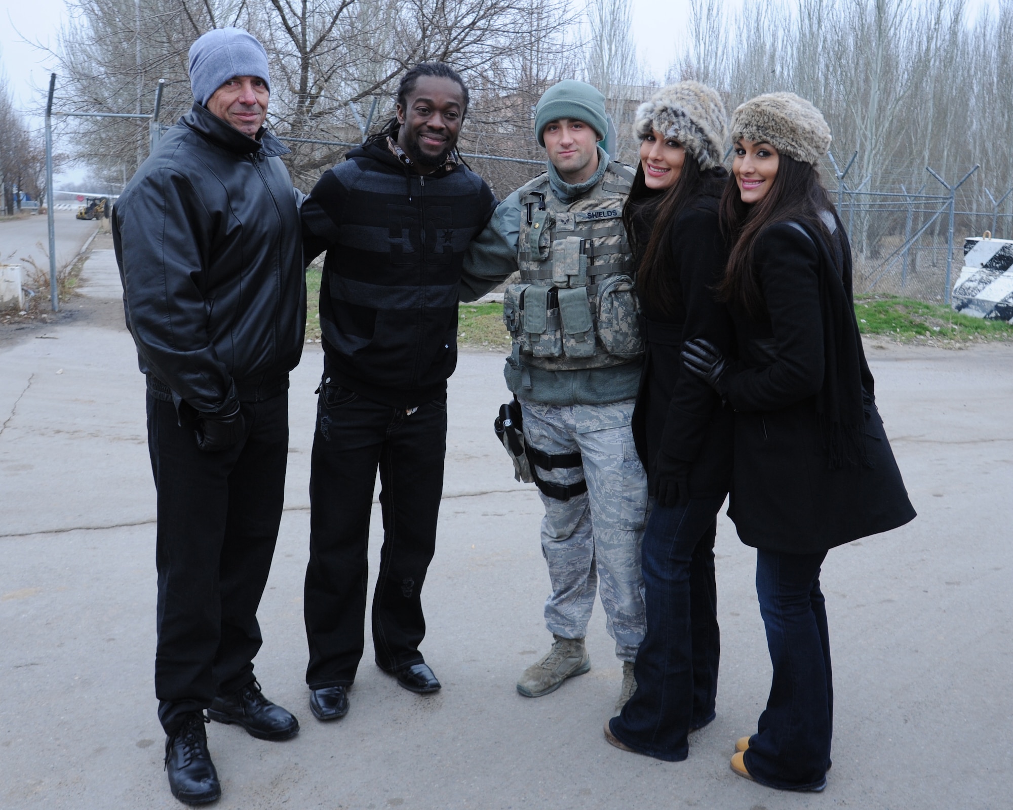 From left Vince McMahon, Kofi Kingston, and Nikki and Brie Bella pose with Senior Airman Sean Shields during the Armed Forces Entertainment Handshake Tour visit to the Transit Center at Manas, Kyrgyzstan, Dec. 2. McMahon is the CEO of World Wrestling Entertainment, Kingston is a WWE wrestler, and Nikki and Brie are WWE divas. Shields is an entry controller assigned to the 376th Expeditionary Security Forces Squadron deployed from the 436th Security Forces Squadron at Dover Air Force Base, Del. (U.S. Air Force photo/Tech. Sgt. Hank Hoegen)