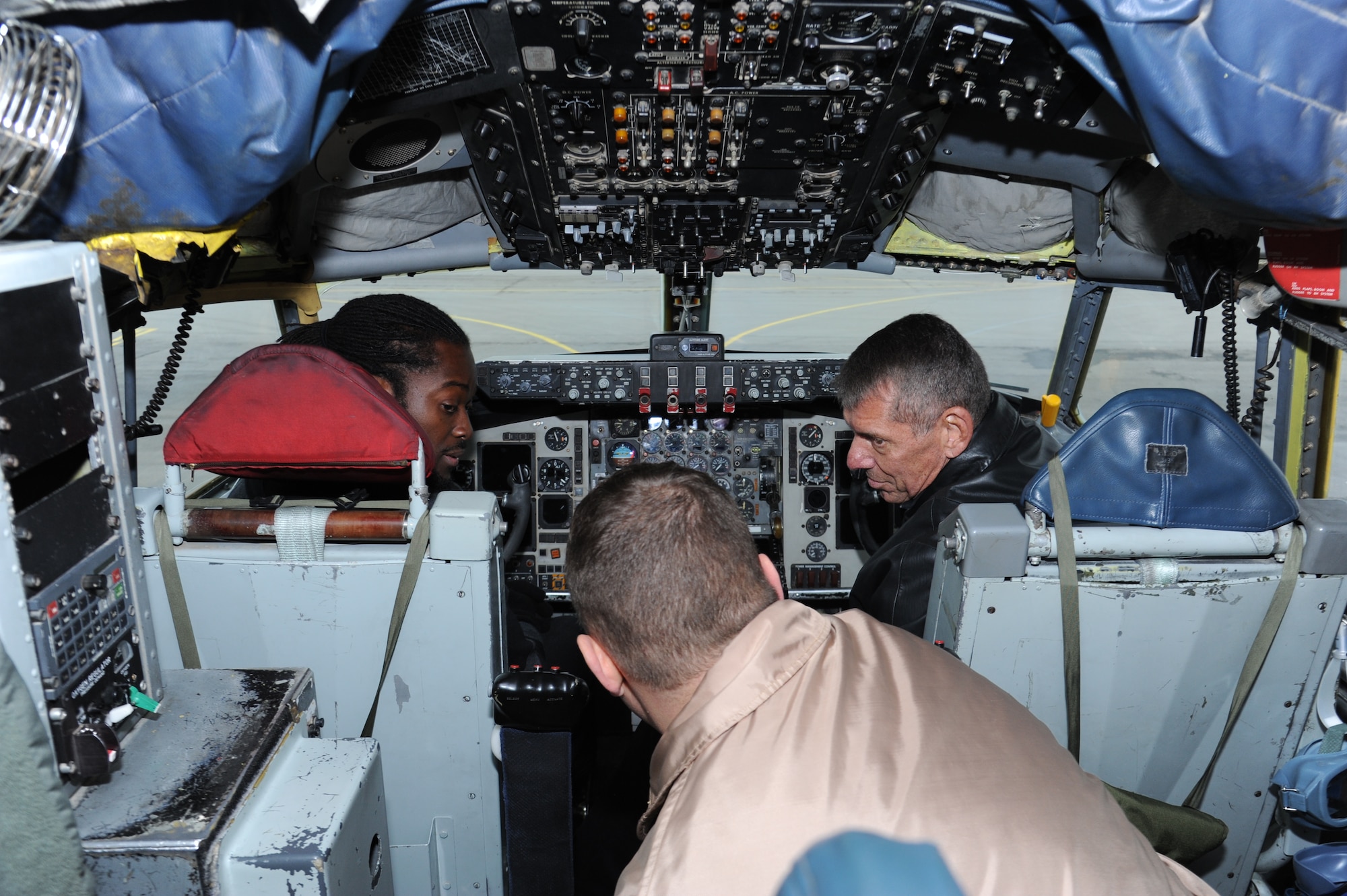 Lt. Col. Peter Tschohl (center), 22nd Expeditionary Aerial Refueling Squadron commander, explains the basics of the KC-135 Stratotanker to Vince McMahon, World Wrestling Entertainment CEO (right), and Kofi Kingston, WWE wrestler, at the Transit Center at Manas, Kyrgyzstan, Dec. 2. McMahon and Kingston visited as part of the Armed Forces Entertainment Handshake tour showing support for service members deployed through the holidays. Tschohl is deployed from the 384th Air Refueling Squadron at McConnell Air Force Base, Kan.(U.S. Air Force photo/Tech. Sgt. Hank Hoegen)