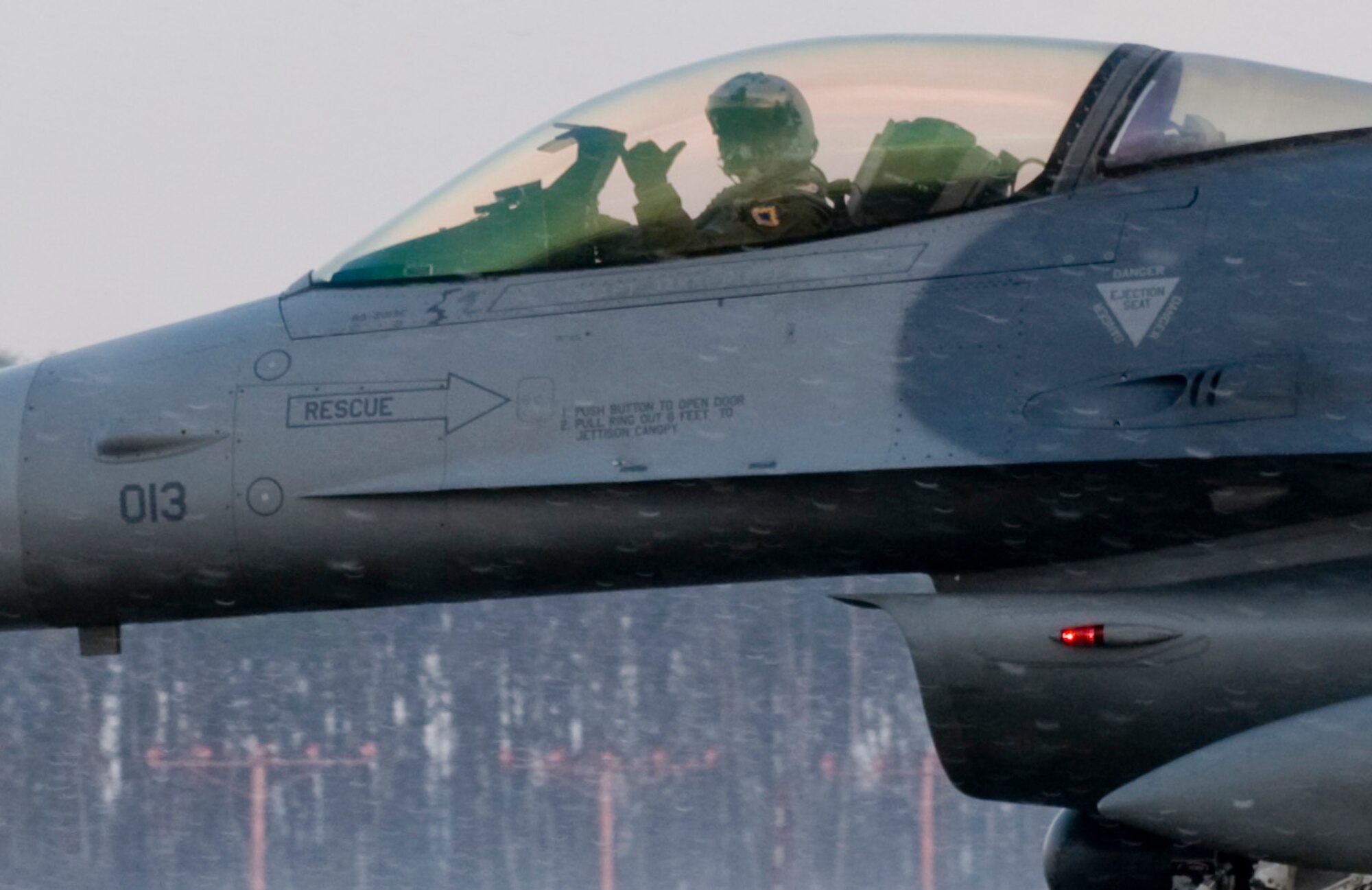MISAWA AIR BASE, Japan – A pilot displays the hand signal of his squadron as he taxis an F-16 Fighting Falcon on the 35th Fighter Wing’s aircraft ramp here Dec. 5. The F-16, belonging to the 35th Fighter Squadron from Kunsan Air Base, South Korea, will be used to simulate an “aggressor” aircraft during the 35th FW’s Operational Readiness Inspection. More than 130 inspectors comprise a Pacific Air Force Inspector General Team who are evaluating the wing’s deployment readiness. (U.S. Air Force photo/Senior Airman Jess Lockoski) 