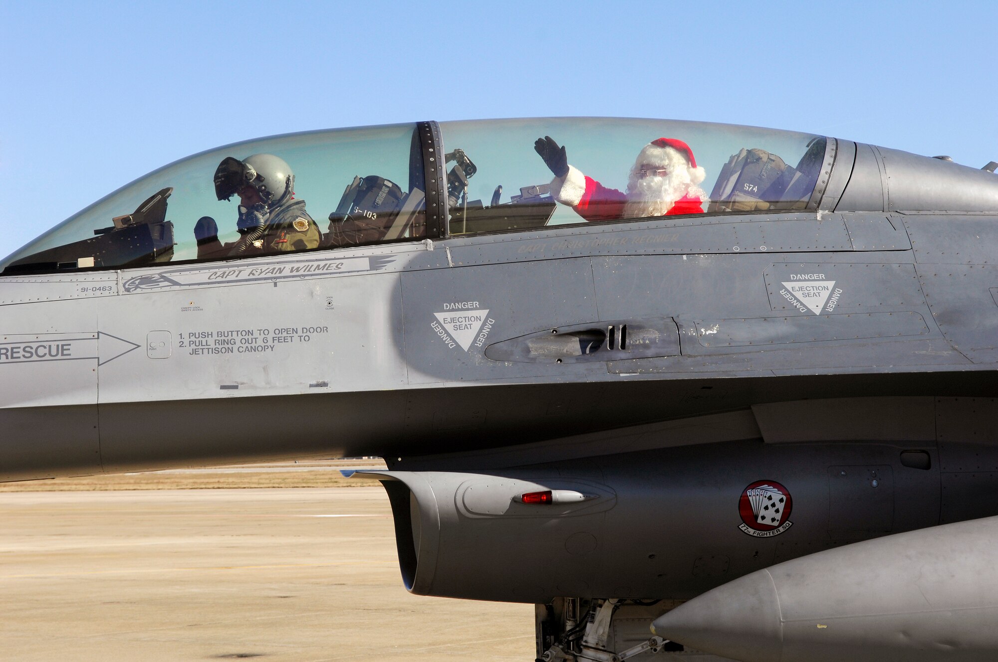 U.S. Air Force Lt. Col. Johnny Vargas, 77th Fighter Squadron commander, sits in a F-16 Fighting Falcon after flying Santa to Shaw for the 20th Operations Group Christmas Party, Shaw Air Force Base, S.C. Dec. 3, 2011. (U.S. Air Force photo by Airman 1st Class Ashley L. Gardner/ Released)