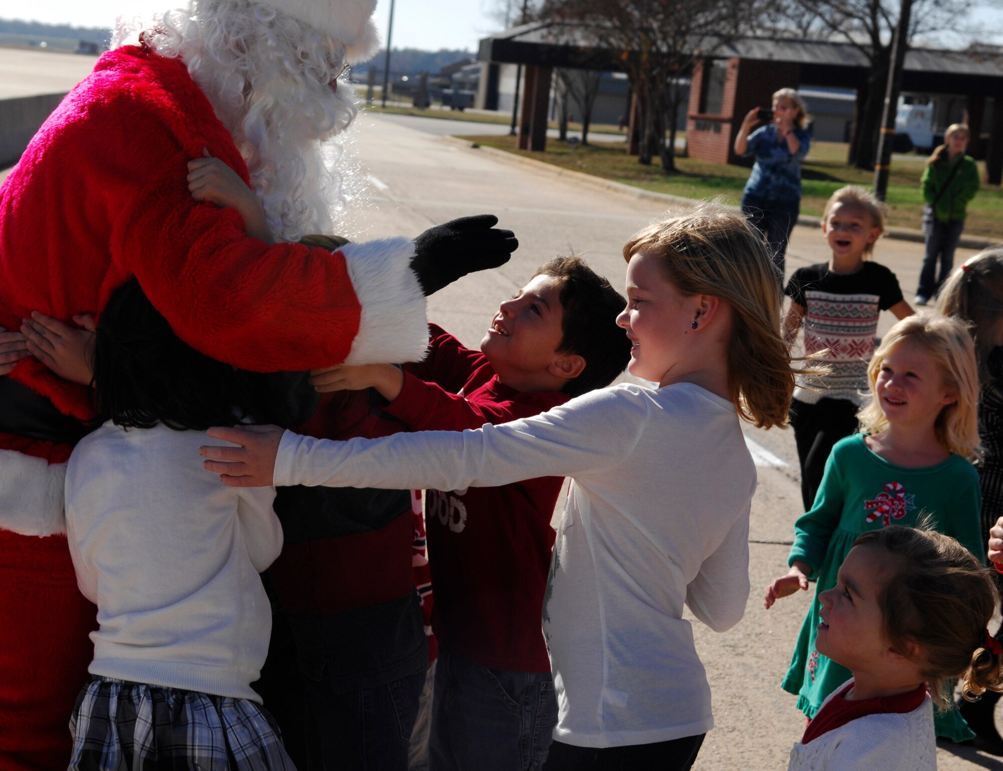 Santa gives kids a hug at the 20th Operations Group Christmas Party, Shaw Air Force Base, S.C. Dec. 3, 2011. (U.S. Air Force photo by Airman 1st Class Ashley L. Gardner/ Released)