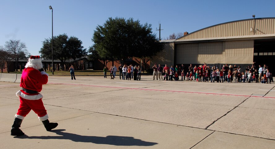 Santa walks towards the crowd of kids after his F-16 Fighting Falcon landing, Shaw Air Force Base, S.C. Dec. 3, 2011. (U.S. Air Force photo by Airman 1st Class Ashley L. Gardner/ Released) 