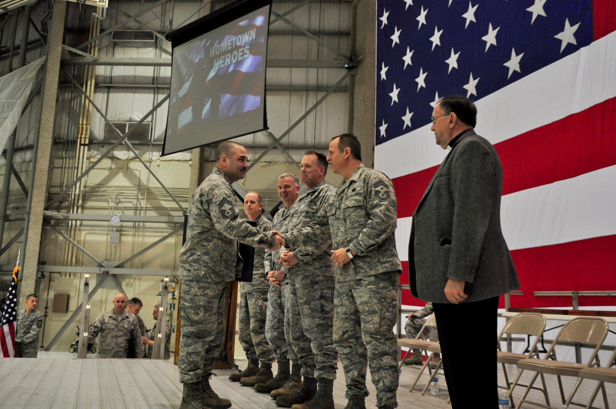 Chief Master Sgt. Christopher Chatham, 128th Air Refueling Wing maintenance squadron superintendent, shakes hands with Command Chief Master Sgt. Joe Parlato during a Hometown Heroes Salute Campaign award ceremony at the 128th Air Refueling Wing, Milwaukee, on Sunday, December 4, 2011.  Chatham received a wood-framed letter of appreciation signed by the director and the command chief master sergeant of the Air National Guard for his duty while deployed overseas.  The Hometown Heroes Salute Campaign is an Air National Guard event that recognizes Airmen who have deployed overseas for more than 30 days.  Air National Guard photo by Tech. Sgt. Tom Sobczyk.