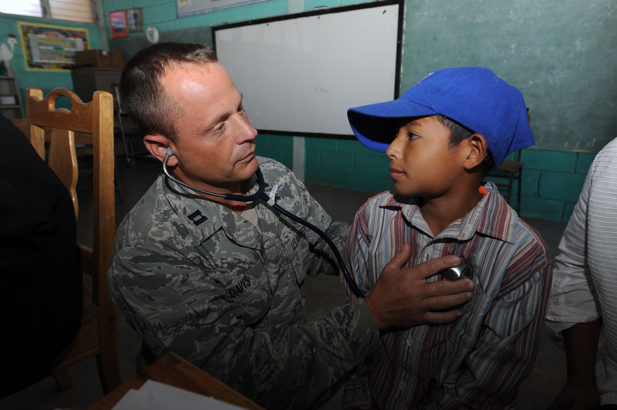 Capt. James Davis, a Joint Task Force-Bravo Medical Element physician’s assistant, performs a check up on a Honduran boy during a Medical Readiness Training Exercise Nov. 29, 2011, at a school in Choluteca, Honduras.  More than 20 medical personnel from JTF-Bravo along with their Honduran partners, back rounding in various medical fields, military members, Boy Scouts, and the Honduran Ministry of Health, provided general medical care to over 2,800 flood victims. (U.S. Air Force photo/Tech. Sgt. Matthew McGovern)    