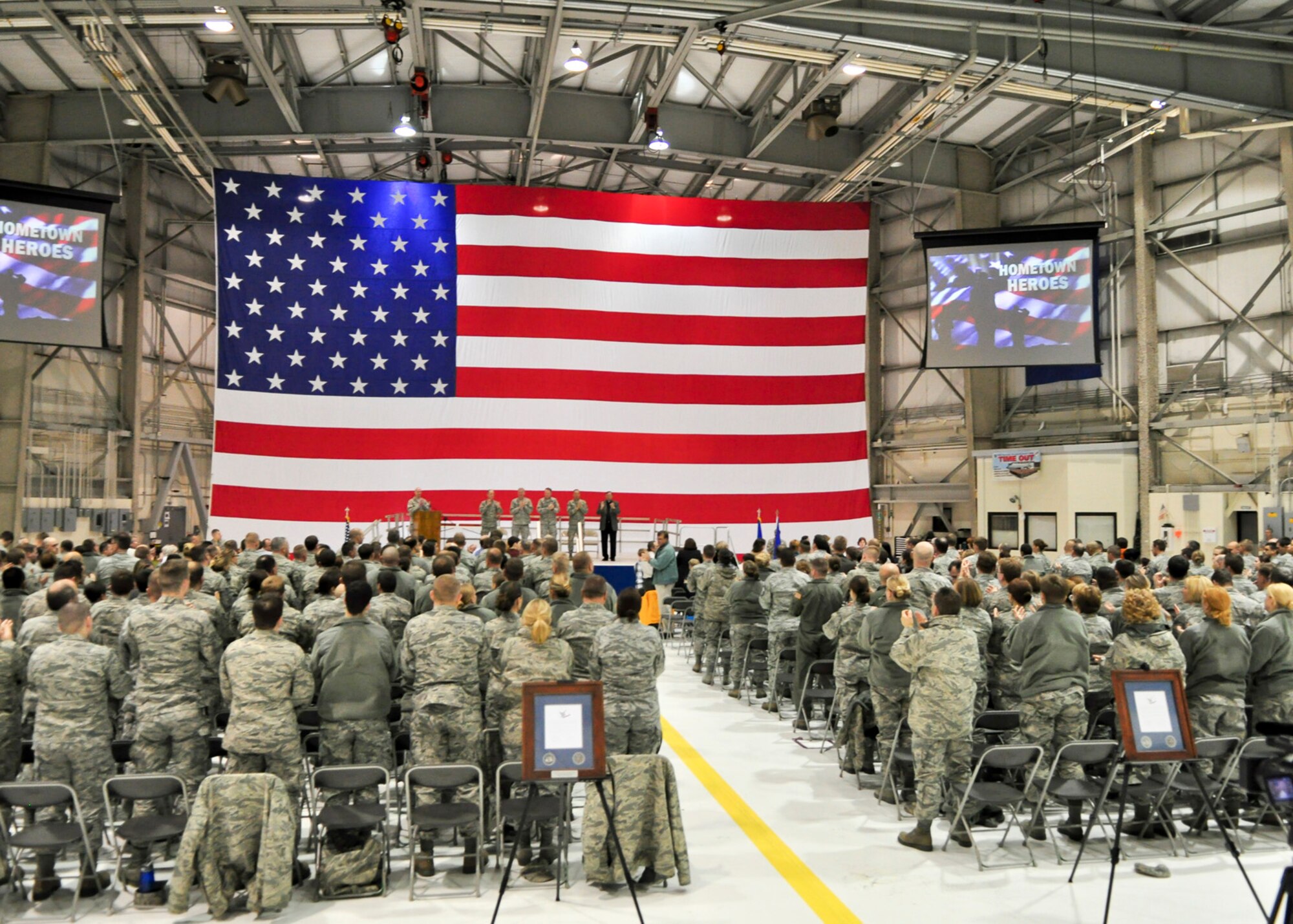 Senior military and civilian officials lead applause at the conclusion of a Hometown Heroes Salute Campaign award ceremony at the 128th Air Refueling Wing, Milwaukee, on Sunday, December 4, 2011.  Over 500 Airmen and family members attended the award ceremony wherein over 100 Airmen were formally recognized for their contributions while deployed overseas.  The Hometown Heroes Salute Campaign is an Air National Guard event that recognizes Airmen who have deployed overseas for more than 30 days.  Air National Guard photo by Tech. Sgt. Tom Sobczyk.