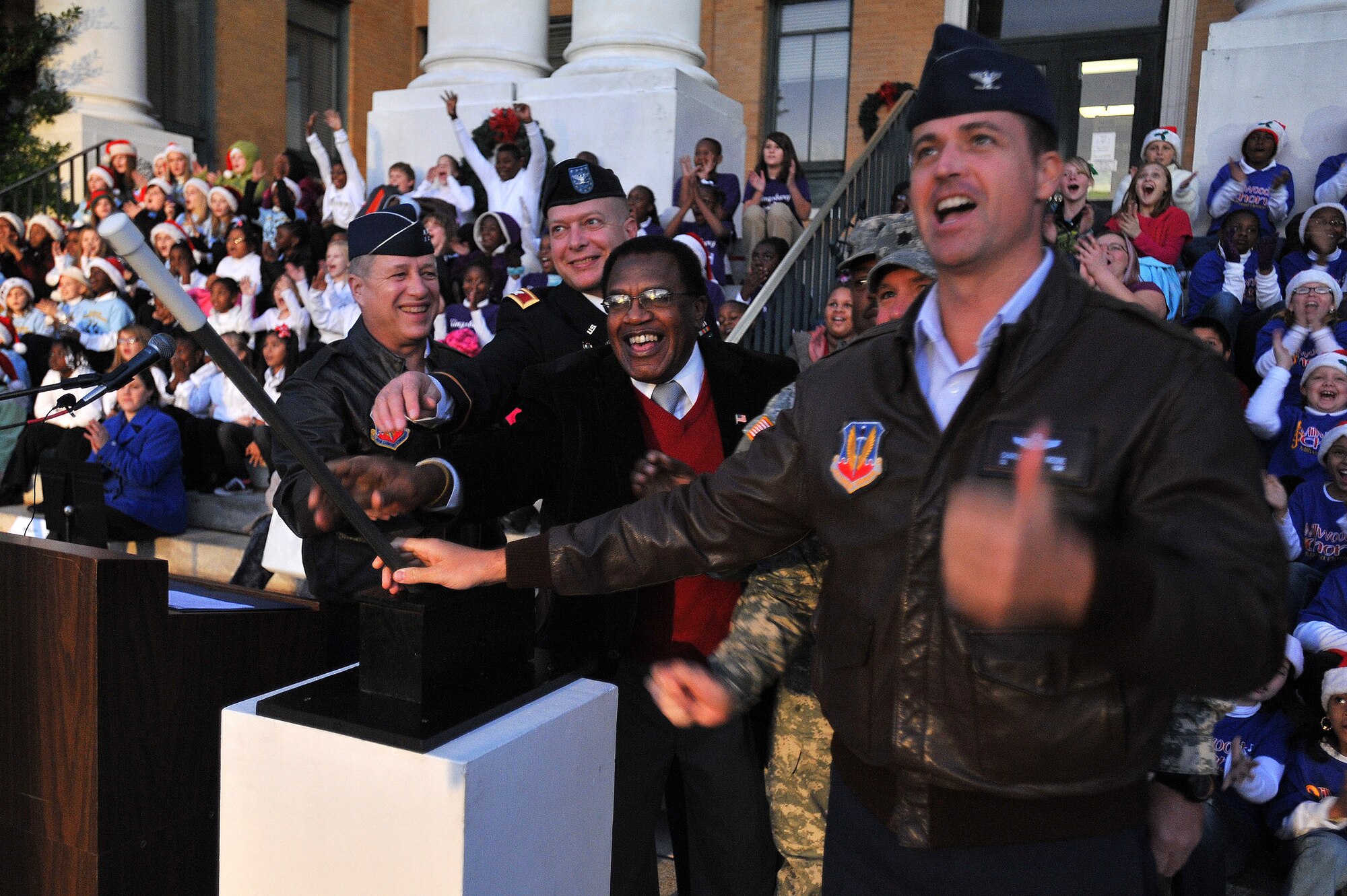 U.S. Air Force Col. Charlie Moore, 20th Fighter Wing commander, (right), and The Honorable Eugene Baten, chairman of the Sumter County Council, (center), along with other military officials flip the switch to light the Sumter Christmas tree on the lawn of the Sumter Courthouse, Dec. 2, 2011, Sumter, S.C. The annual ceremony brought out the holiday spirit as several elementary school choirs performed Christmas carols for those who gathered at the courthouse to witness the celebration. (U.S. Air Force photo by Senior Airman Kenny Holston/Released)


