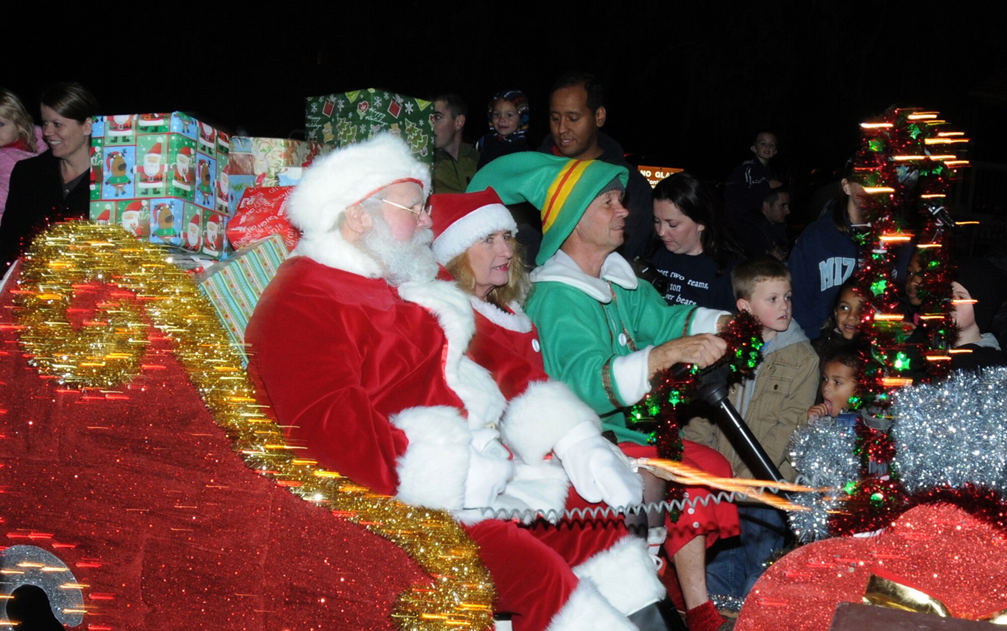 Santa Claus, Mrs. Claus and Santa’s elf, arrives at Holiday in the Park on Santa’s sleigh.  The annual event is held at the Marina Park, Keesler Air Force Base, Miss. Dec. 1, 2011, and included a tree lighting ceremony, hay rides, holiday music by the Keesler Choir, visit with Santa and free food and beverages.  (U.S. Air Force photo by Kemberly Groue)