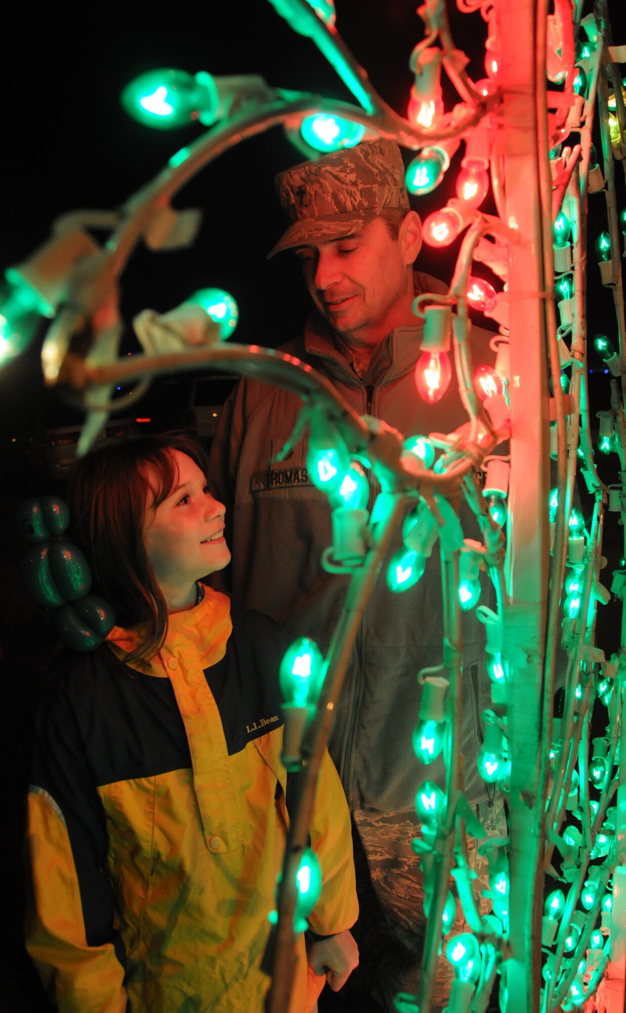 Meredith, 10, and her dad Chaplain (Maj.) Mark Thomas, 81st Training Wing, admire the Christmas light decorations at Keesler’s annual Holiday in the Park at the Marina Park, Keesler Air Force Base, Miss. Dec. 1, 2011.  The event included a tree lighting ceremony, hay rides, holiday music by the Keesler Choir, visit with Santa and free food and beverages.  (U.S. Air Force photo by Kemberly Groue)