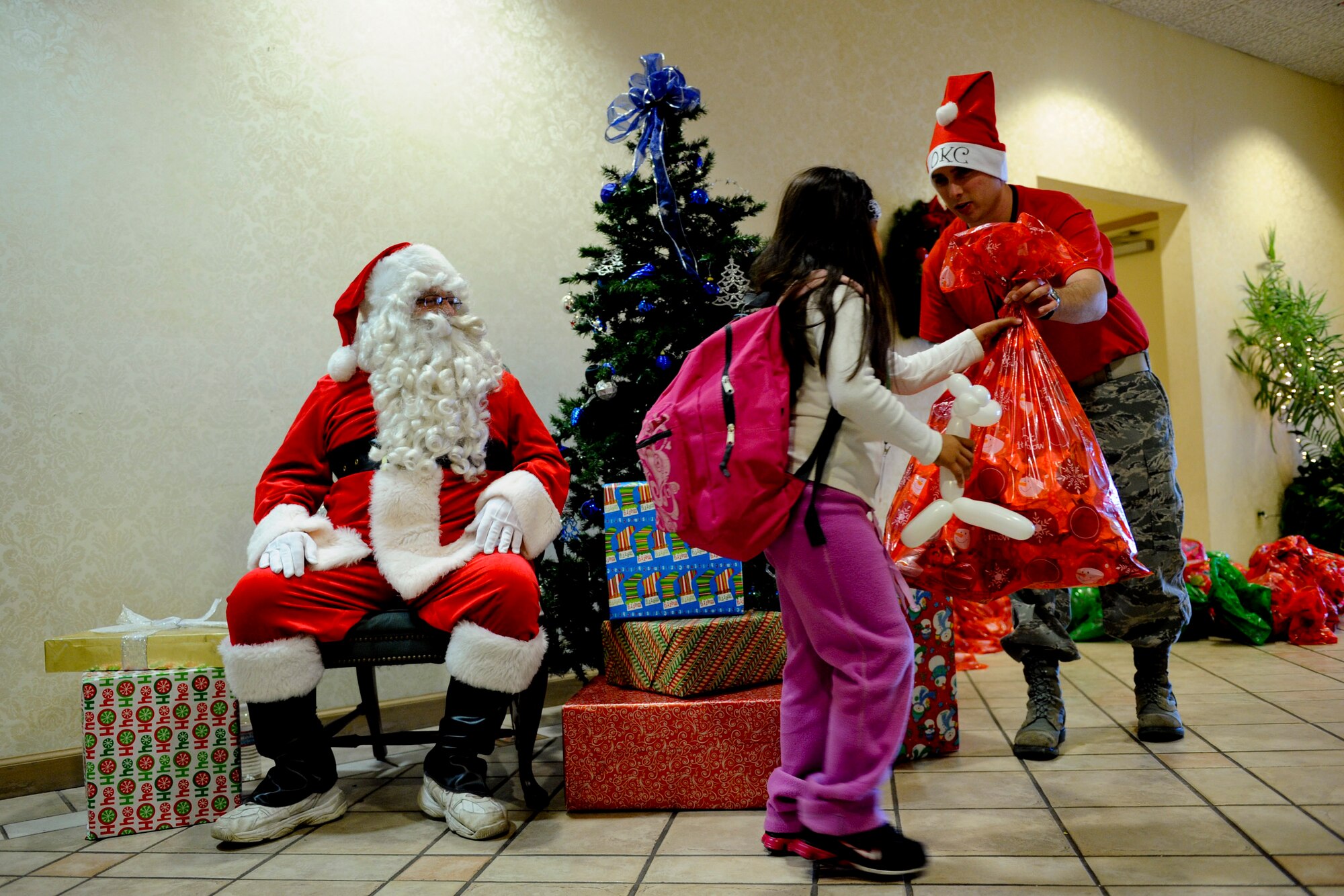 VANDENBERG AIR FORCE BASE, Calif. --A child from the local community receives a gift bag after speaking with Santa Claus during Operation Kids Christmas at the Pacific Coast Club here Saturday, Dec. 3, 2011. OKC is an annual event, organized and run by a private organization, in which approximately 200 local children are brought on base and given the opportunity to play games, meet Santa and enjoy the companionship of volunteer military members. (U.S. Air Force/Staff Sgt. Levi Riendeau)