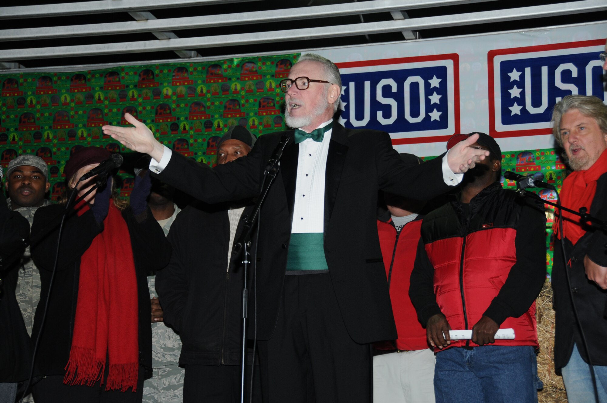 Allan Micksch, Air Force retiree, leads the chapel choir in singing Christmas songs during Keesler’s annual Holiday in the Park at the Marina Park, Keesler Air Force Base, Miss. Dec. 1, 2011.  The event included a tree lighting ceremony, hay rides, holiday music by the Keesler Choir, visit with Santa and free food and beverages.  (U.S. Air Force photo by Kemberly Groue)