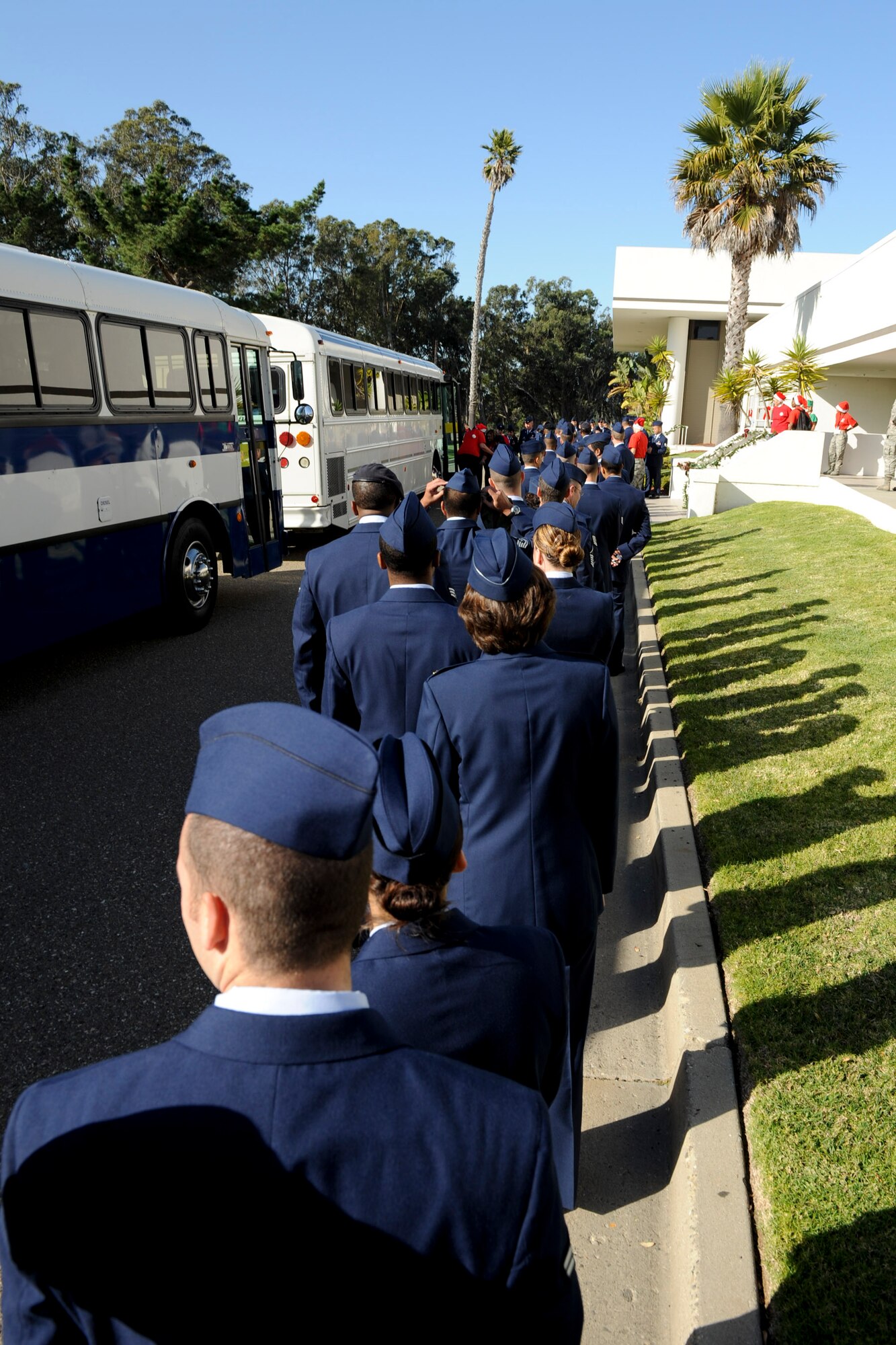 VANDENBERG AIR FORCE BASE, Calif. -- Vandenberg volunteers line up to meet their guests from buses during Operation Kids Christmas at the Pacific Coast Club here Saturday, Dec. 3, 2011. OKC is an annual event, organized and run by a private organization, in which approximately 200 local children are brought on base and given the opportunity to play games, meet Santa and enjoy the companionship of volunteer military members. (U.S. Air Force/Staff Sgt. Levi Riendeau)