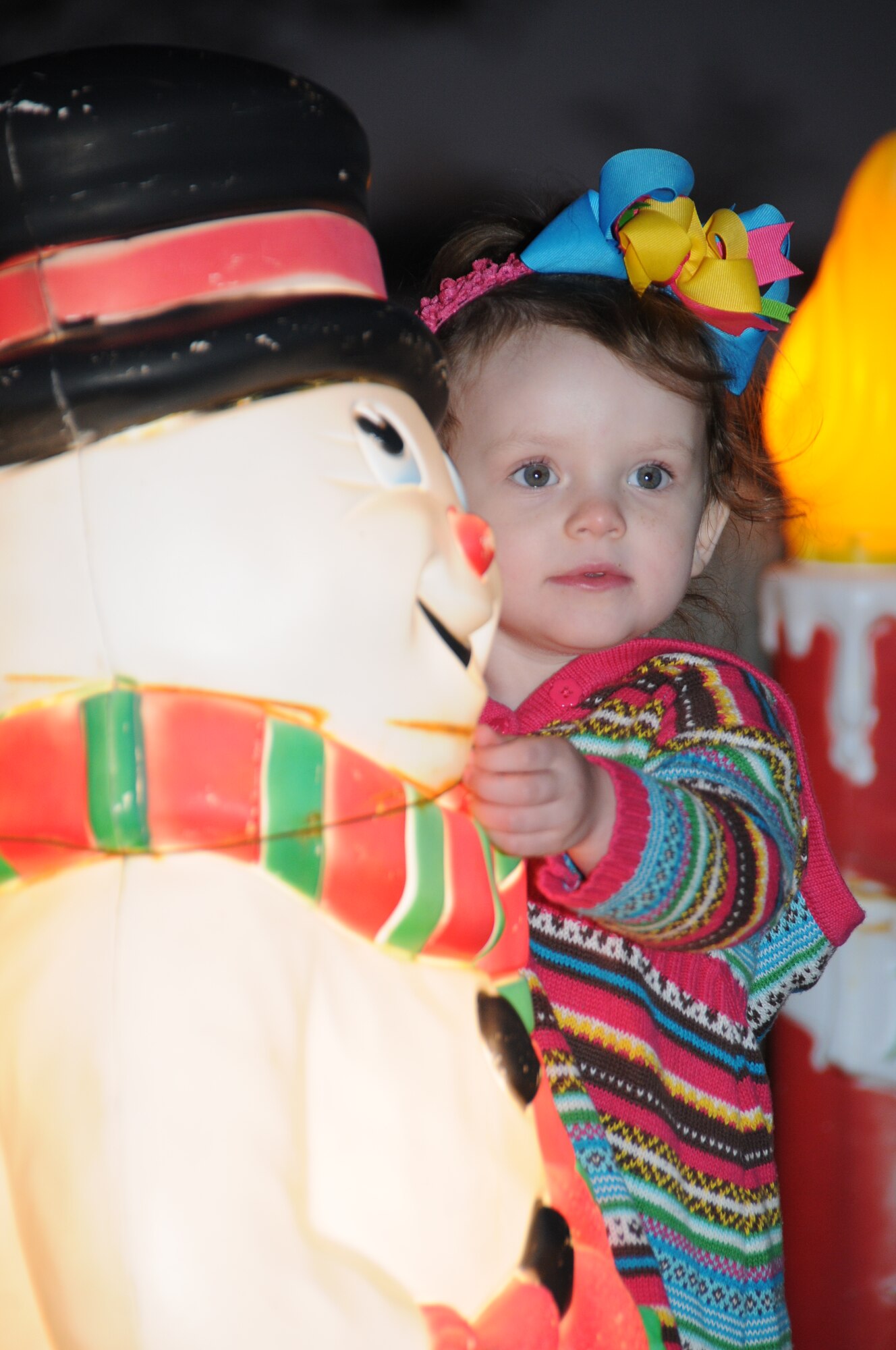 Three-year-old Parker Johnson, dependant of Airman 1st Class Daniel and Katie Johnson, 403rd Wing, gets a close view of Frosty the Snowman during Keesler’s annual Holiday in the Park at the Marina Park, Keesler Air Force Base, Miss. Dec. 1, 2011.  The event included a tree lighting ceremony, hay rides, holiday music by the Keesler Choir, visit with Santa and free food and beverages.  (U.S. Air Force photo by Kemberly Groue)